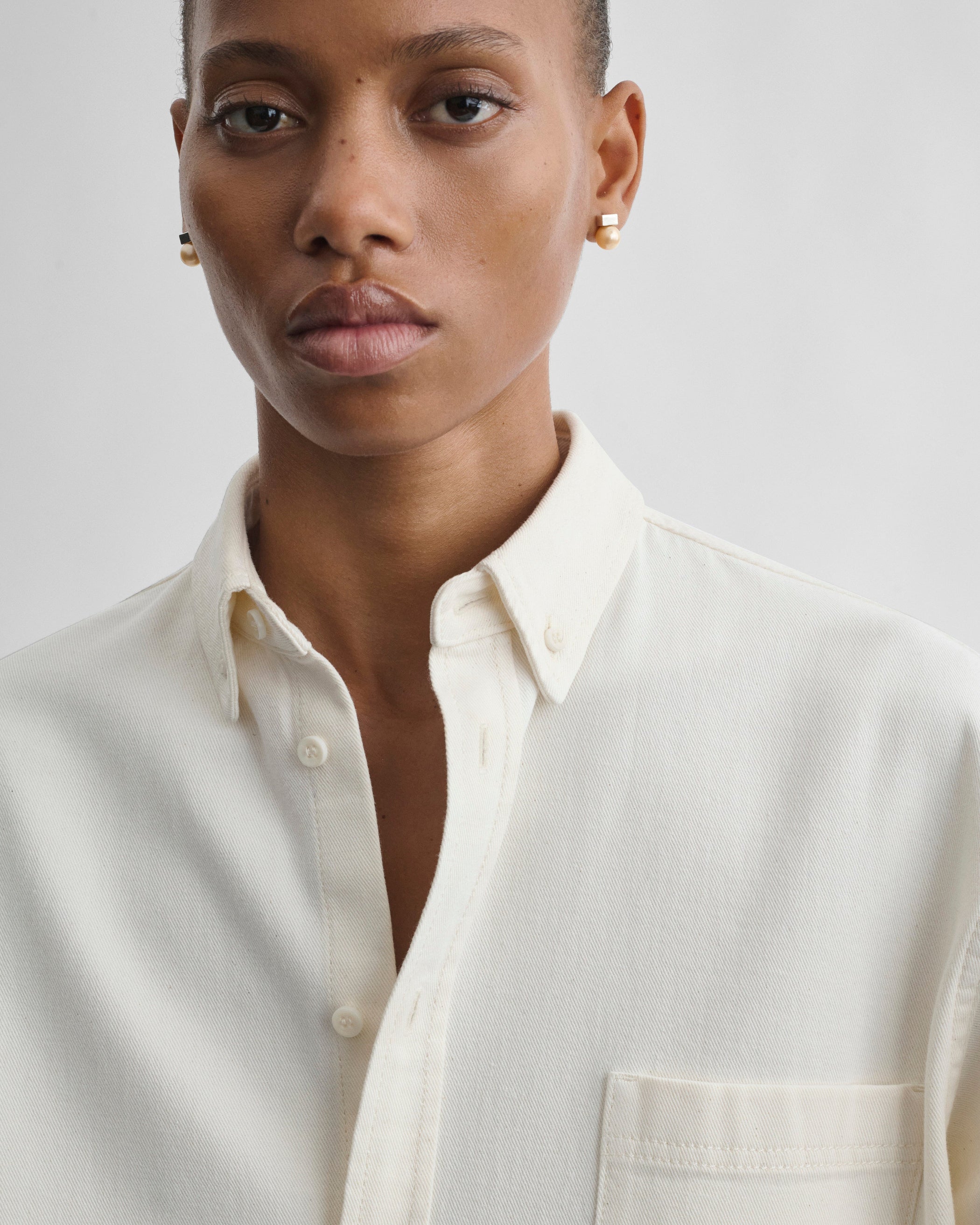 Front detail view of model wearing DENIM SHIRT in chalk cotton
