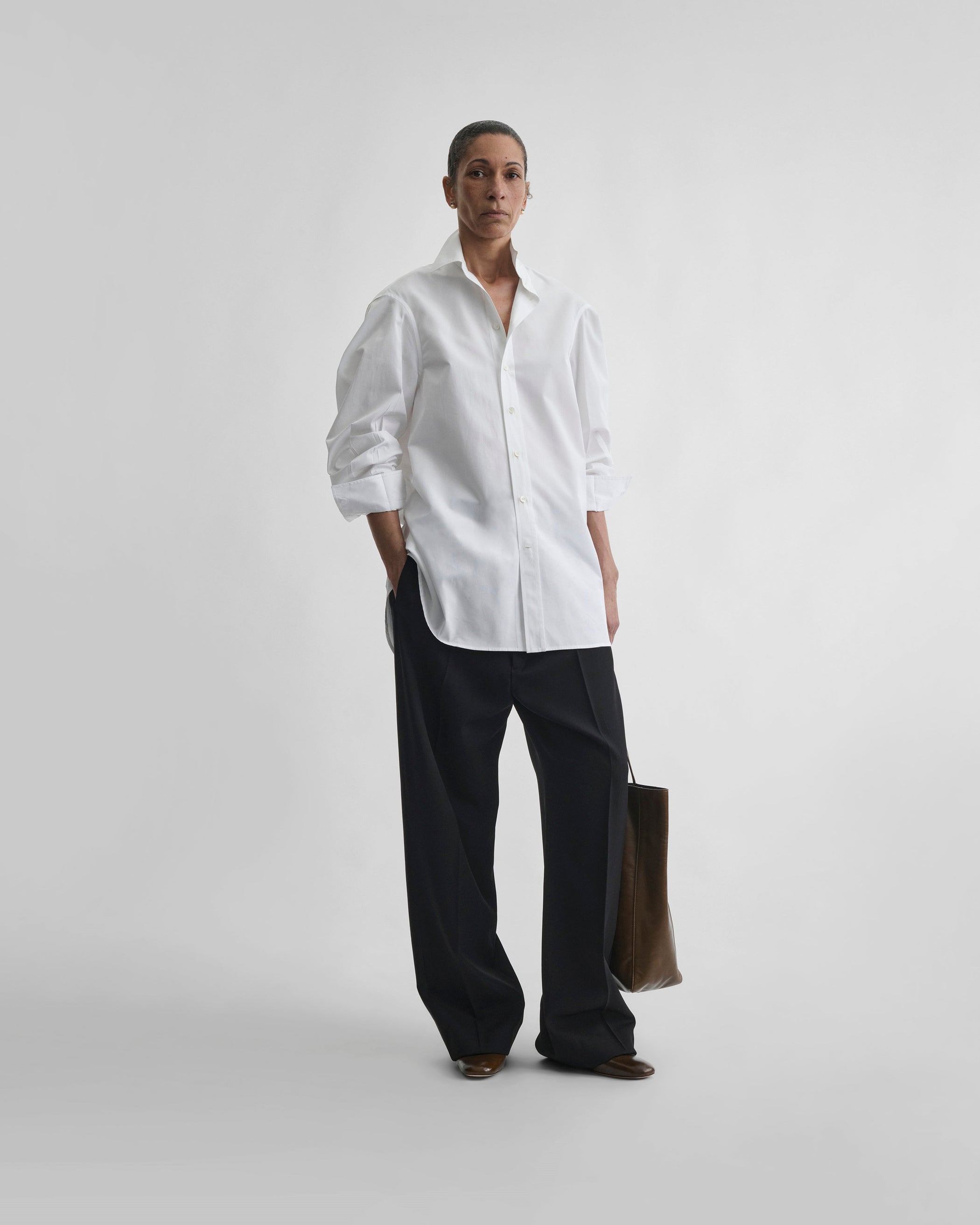 Front view of model wearing TUX SHIRT in white cotton