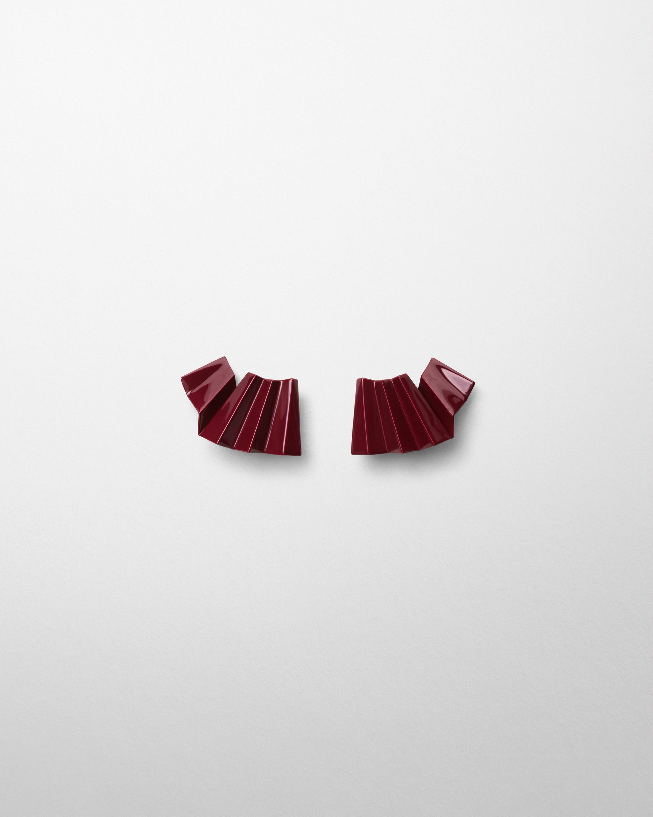 Front view of PLEATED EARRING in oxblood enamel