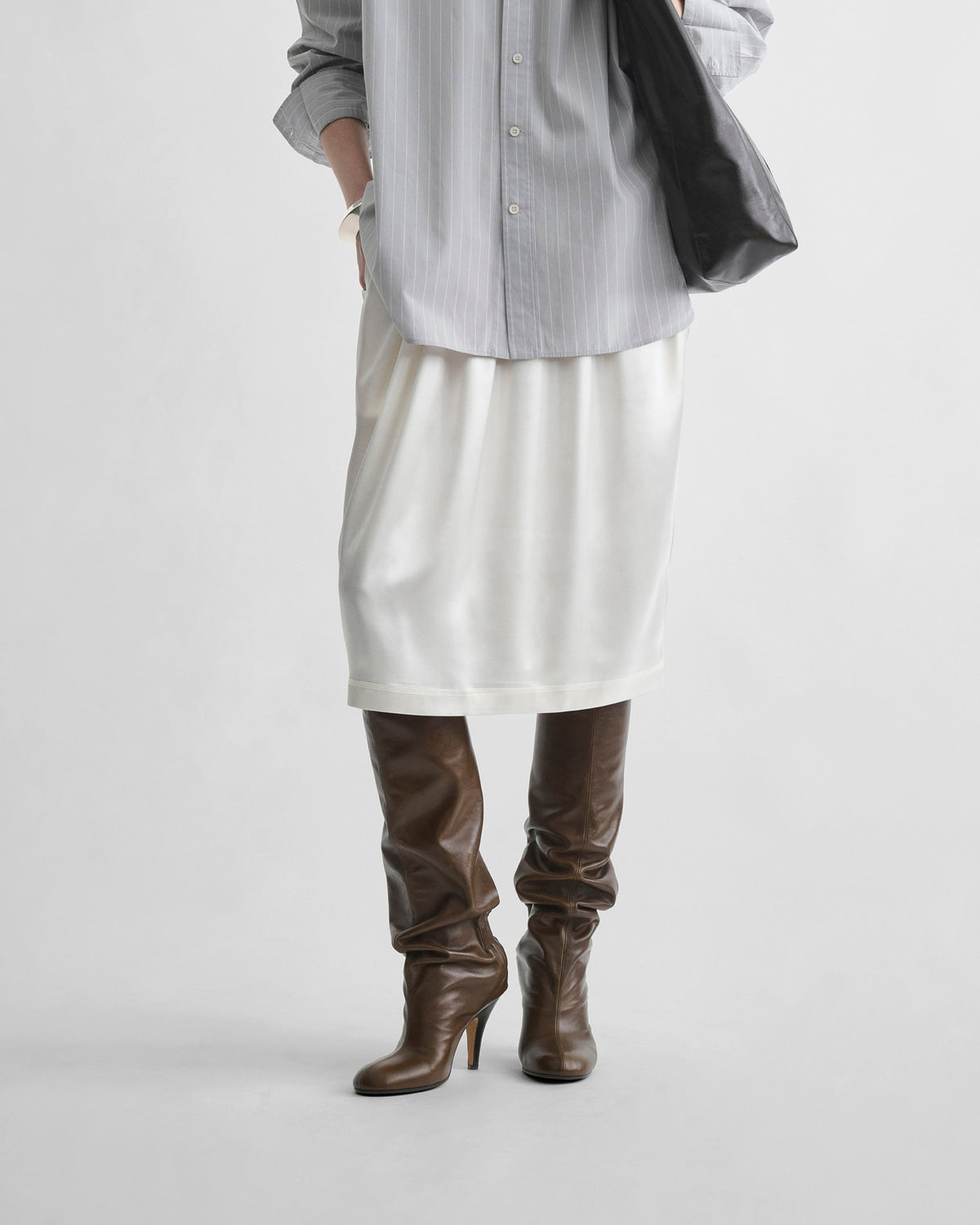 Front detail view of model wearing LIQUID SLIP SKIRT in acid ivory silk