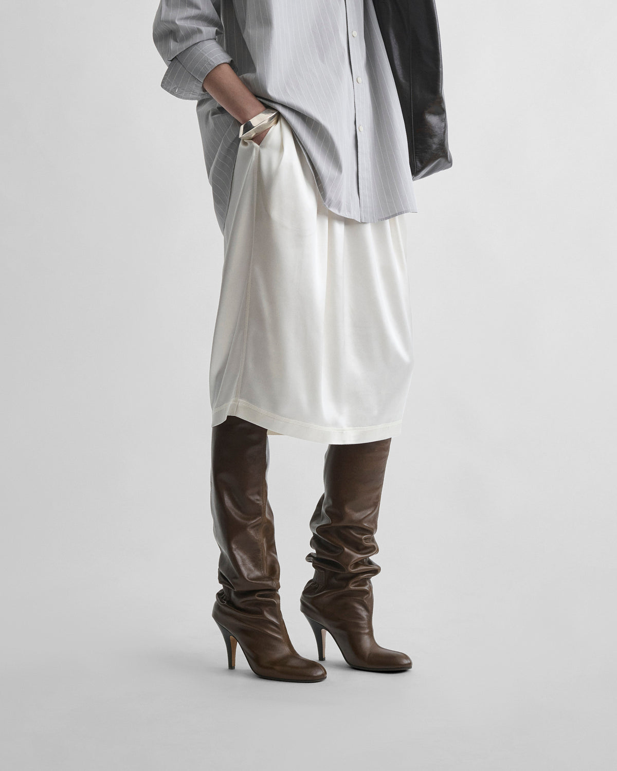 Side view of model wearing LIQUID SLIP SKIRT in acid ivory silk