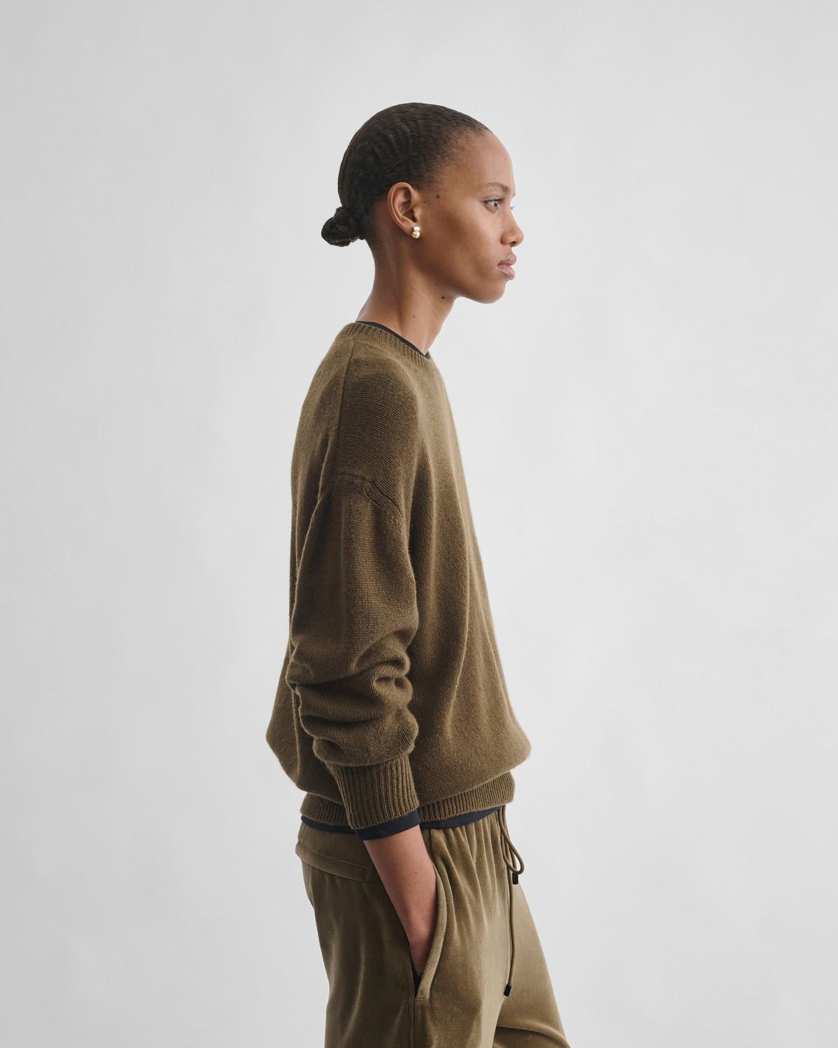 Side view of model wearing CREWNECK SWEATER in khaki cashmere