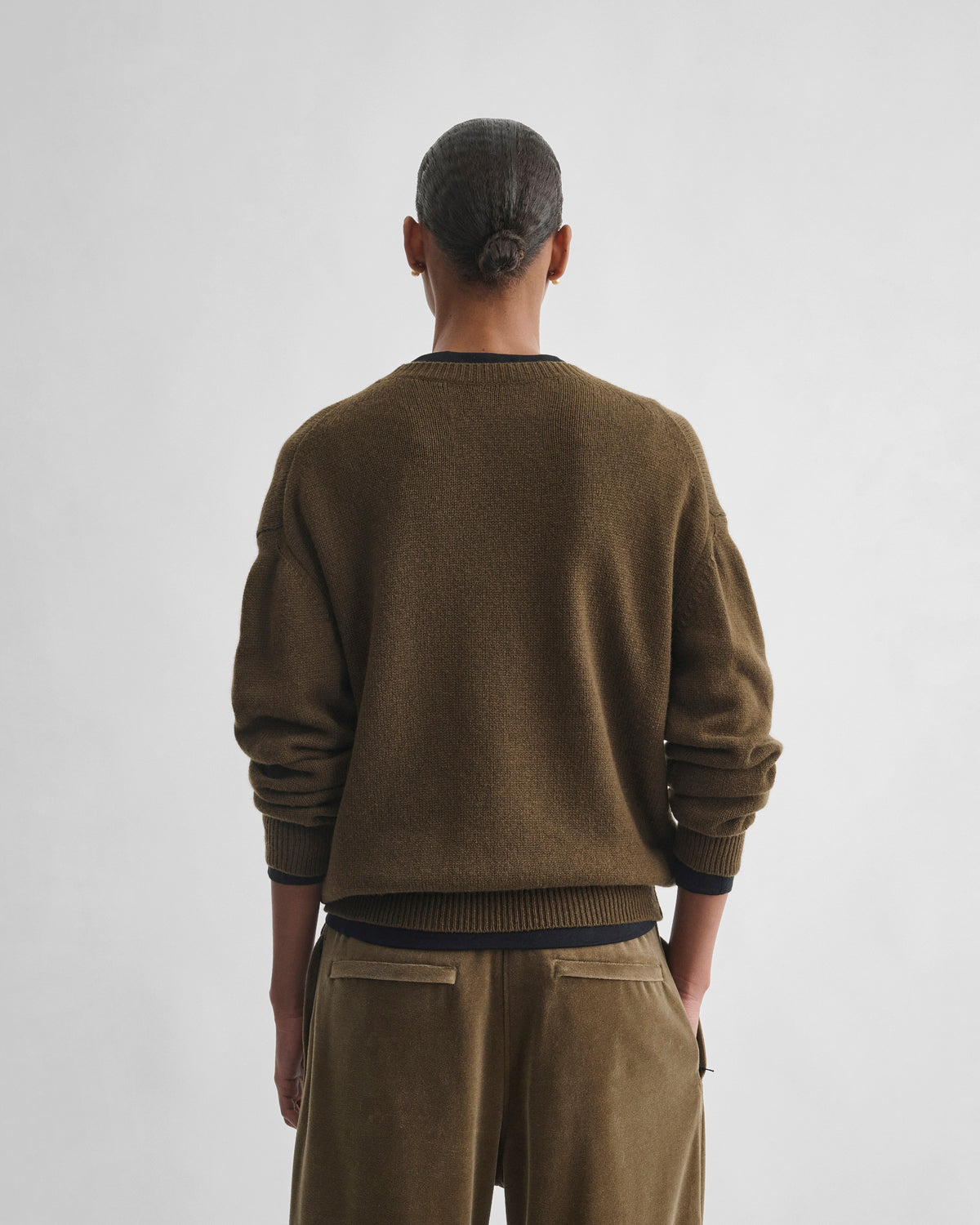 Back view of model wearing CREWNECK SWEATER in khaki cashmere