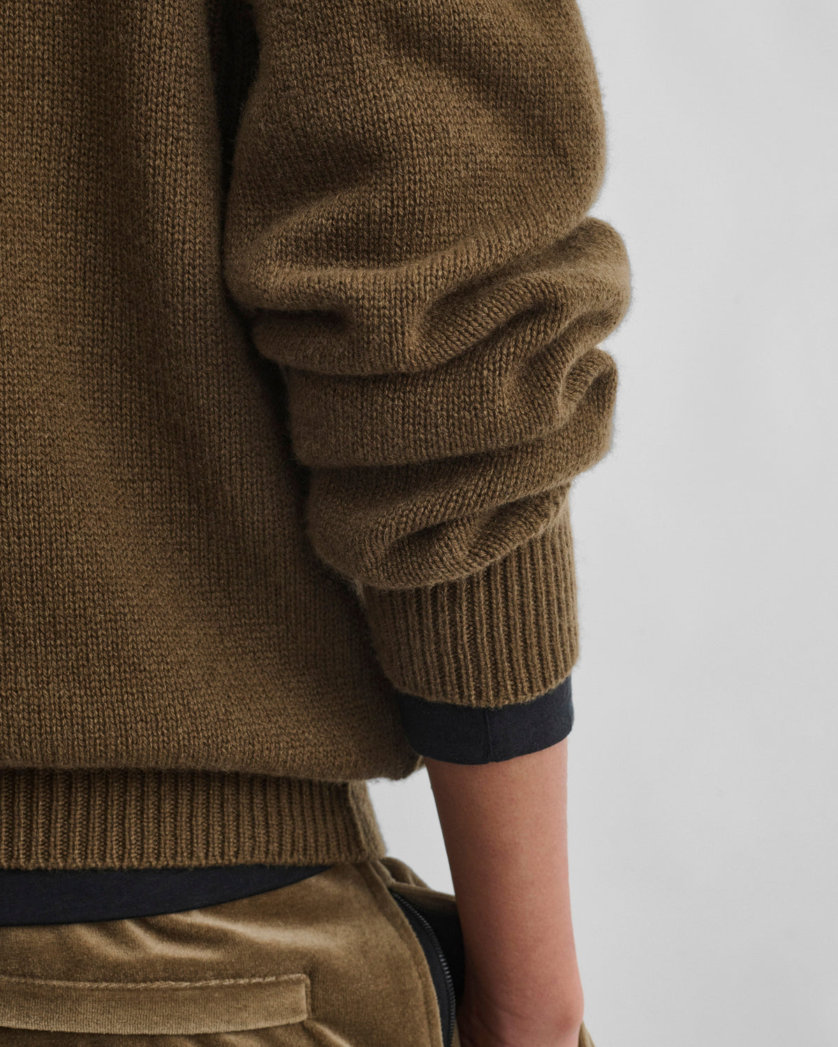 Detail view of model wearing CREWNECK SWEATER in khaki cashmere