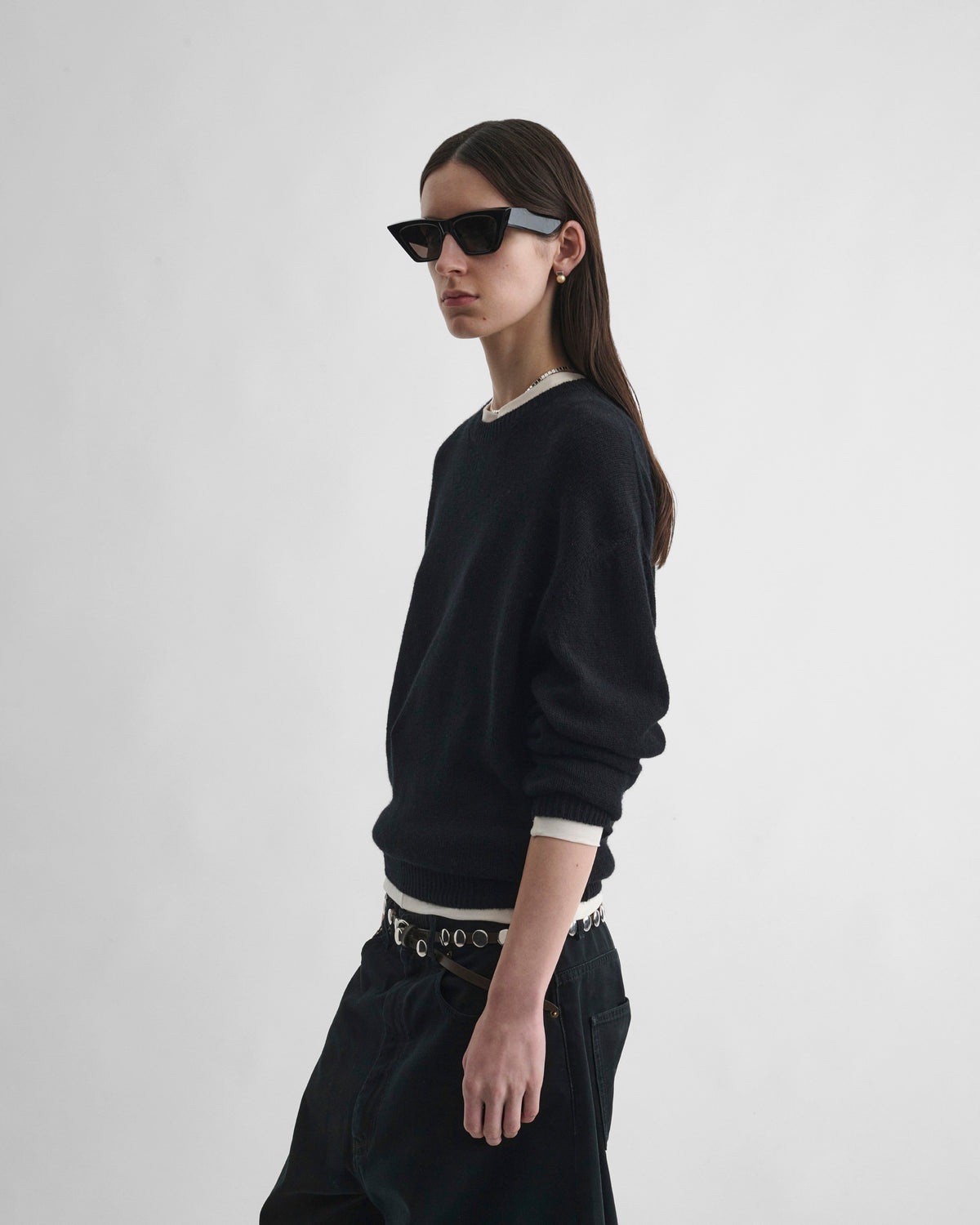 Side view of model wearing CREWNECK SWEATER in black cashmere