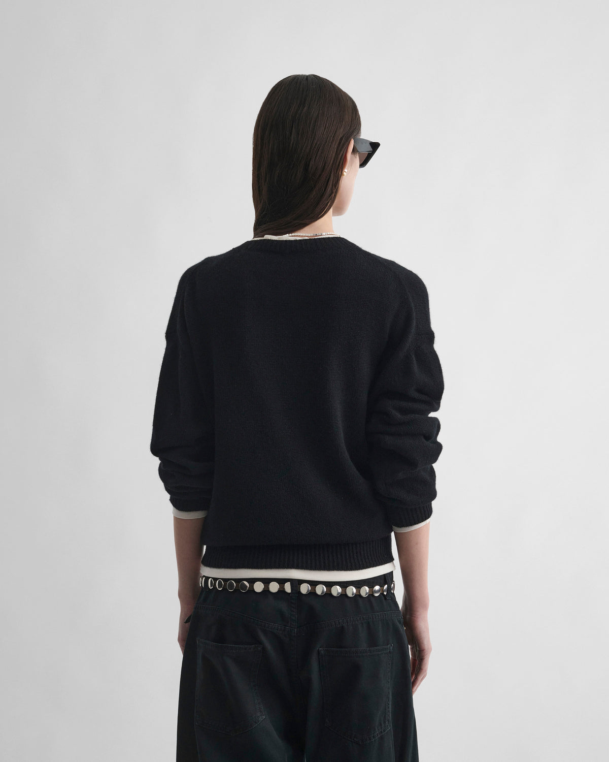 Back view of model wearing CREWNECK SWEATER in black cashmere