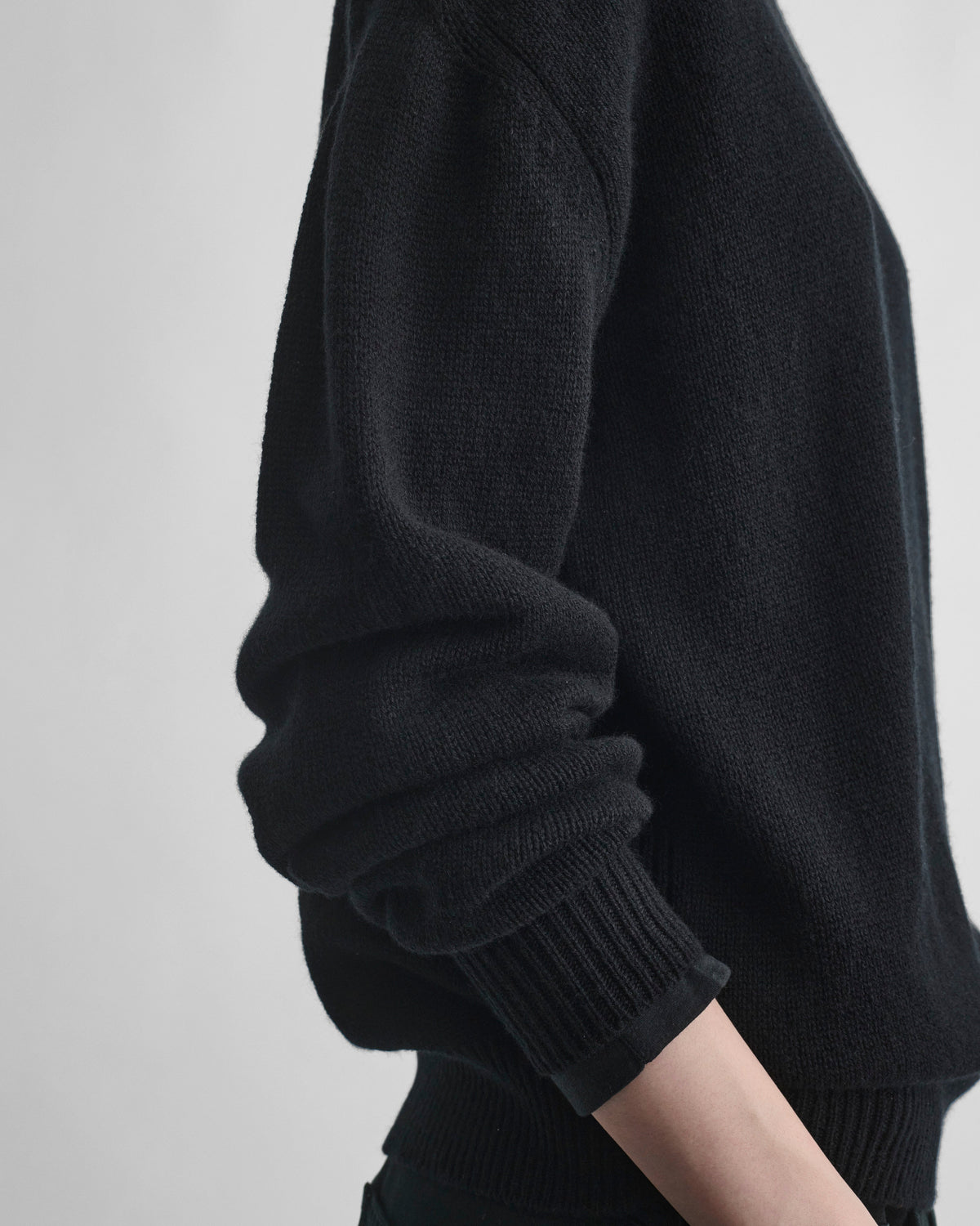 Detail view of model wearing CREWNECK SWEATER in black cashmere