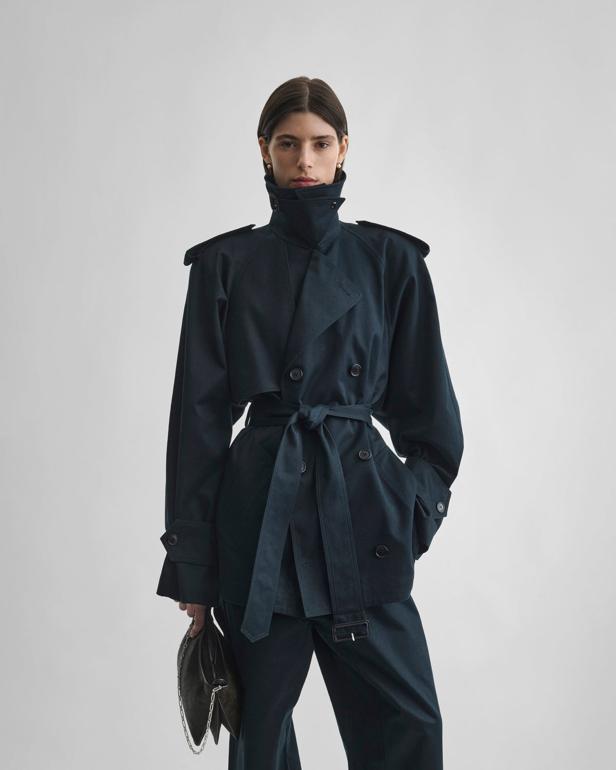 Front view of model wearing CROPPED TRENCH in black ink cotton