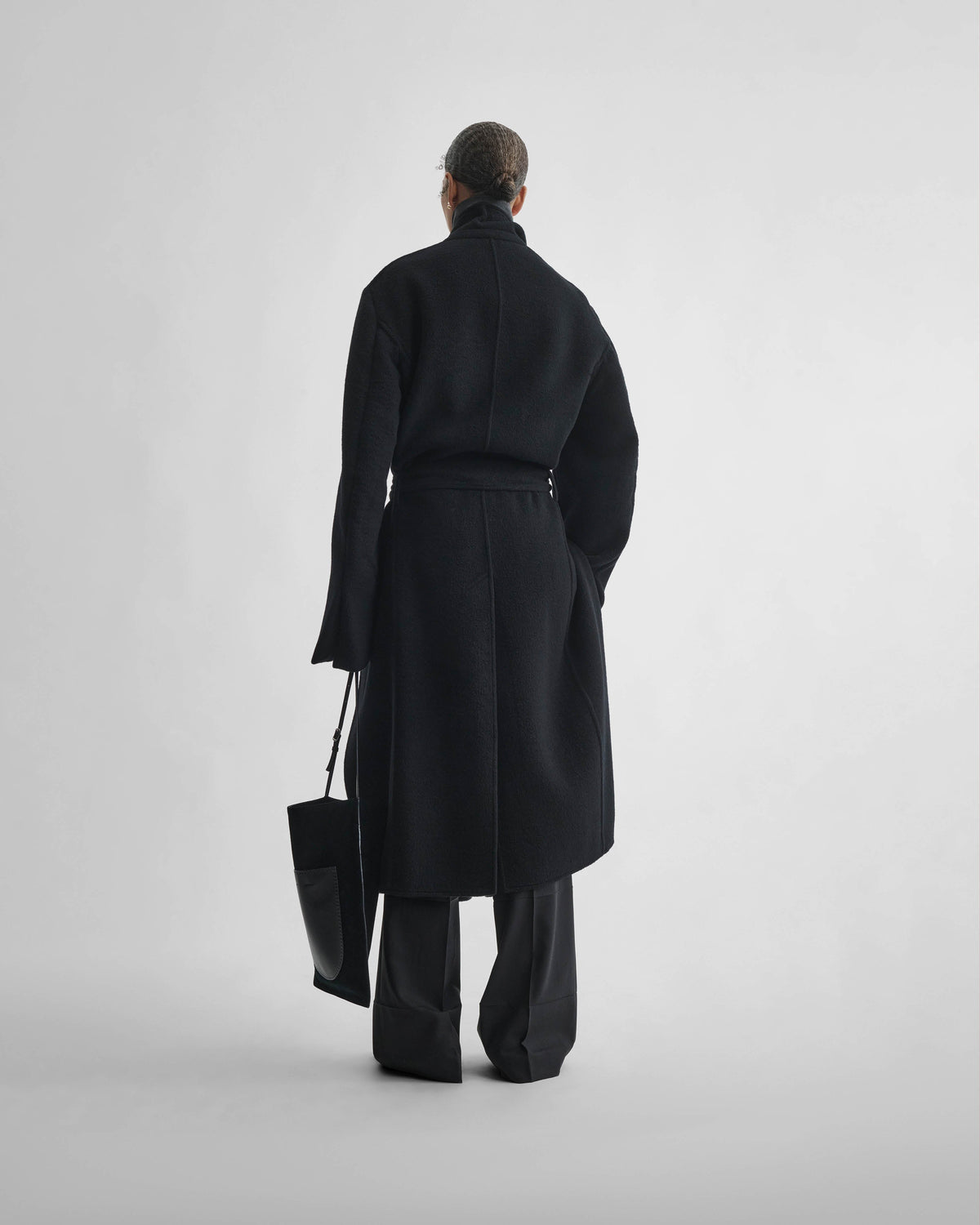 Back view of model wearing BELTED ROBE COAT in black cashmere