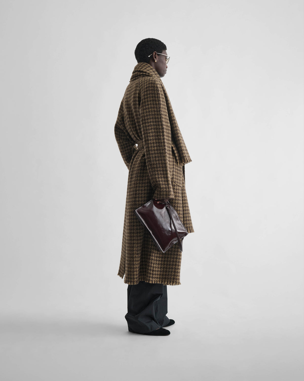 Side view of model wearing BLANKET COAT in brown bronze wool