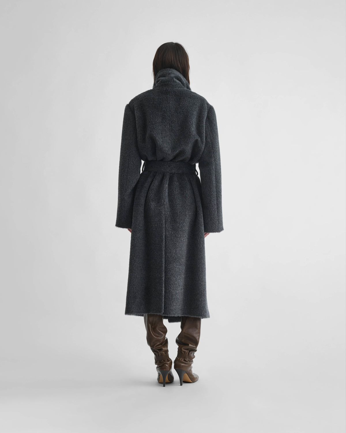 Back view of model wearing BELTED TEDDY COAT in ash shearling