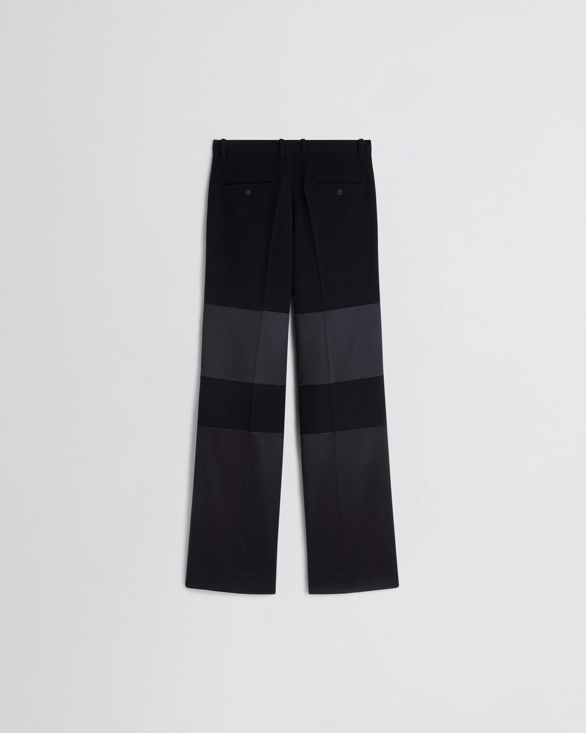 Back view of STACKED TUX TROUSERS in black wool