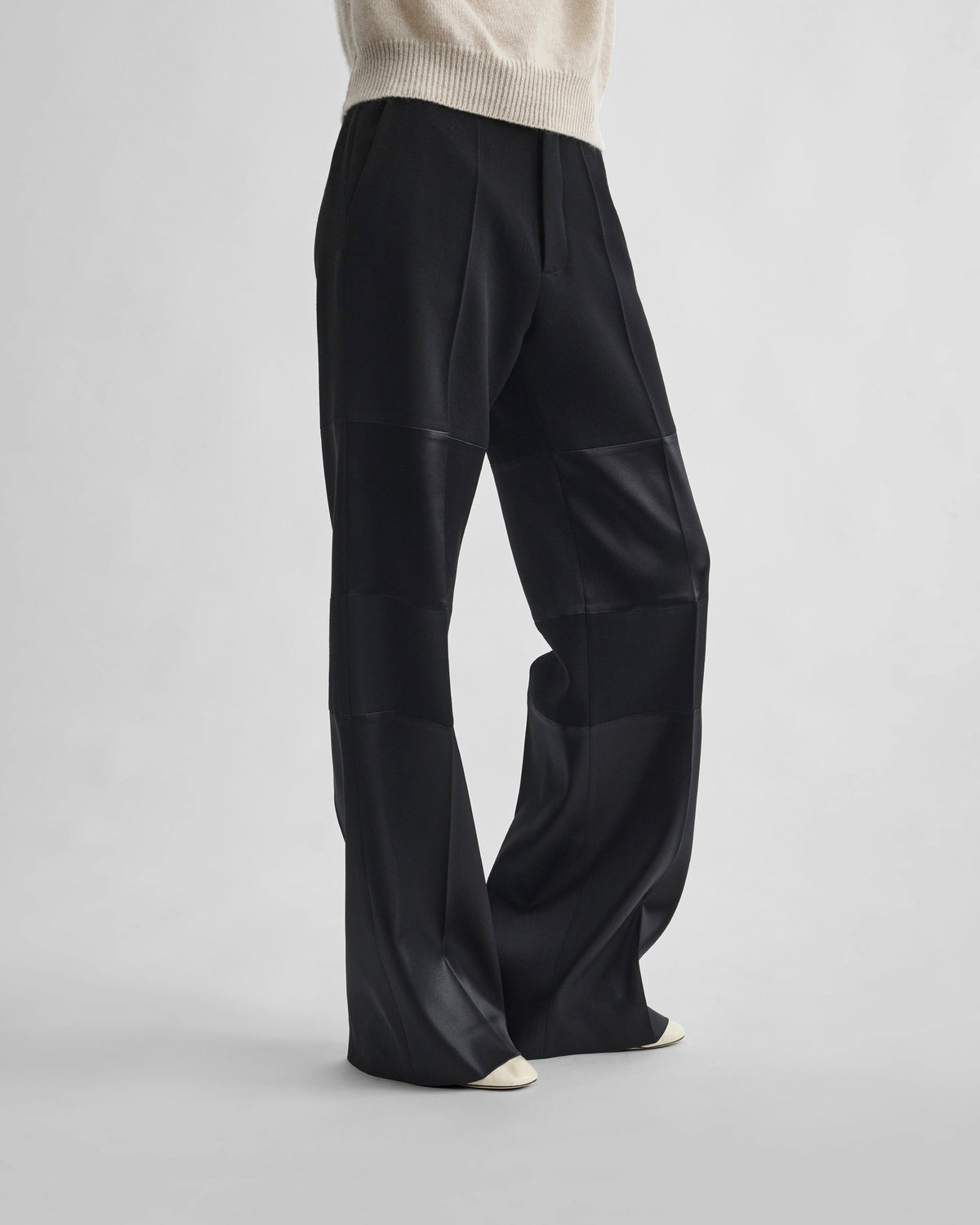 Front view of model wearing STACKED TUX TROUSERS in black wool