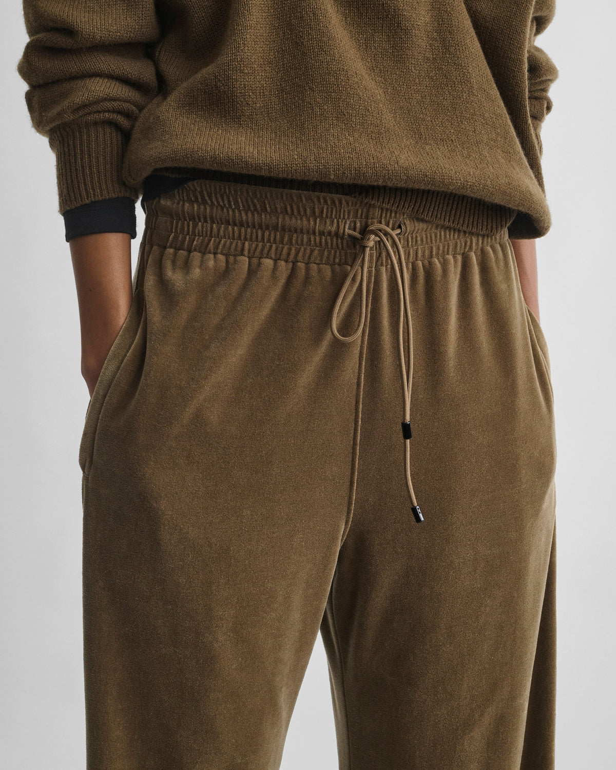 Front detail view of model wearing VELVETEEN JOGGERS in bronze velour