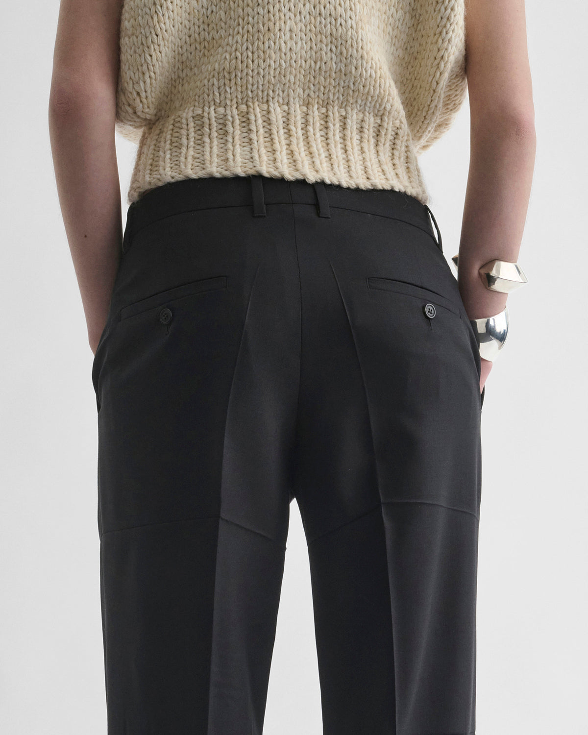 Back view of model wearing TUX BOYISH TROUSERS in black wool