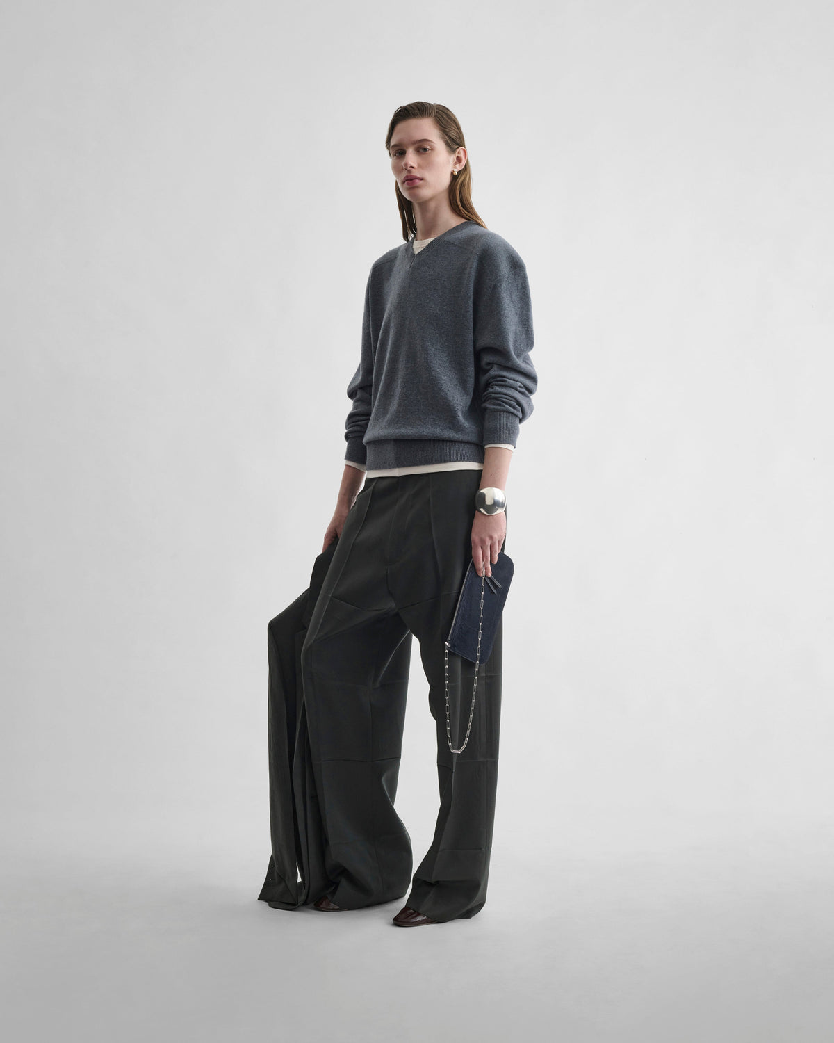 Front view of model wearing PRESSED DROP TROUSERS in green bronze wool