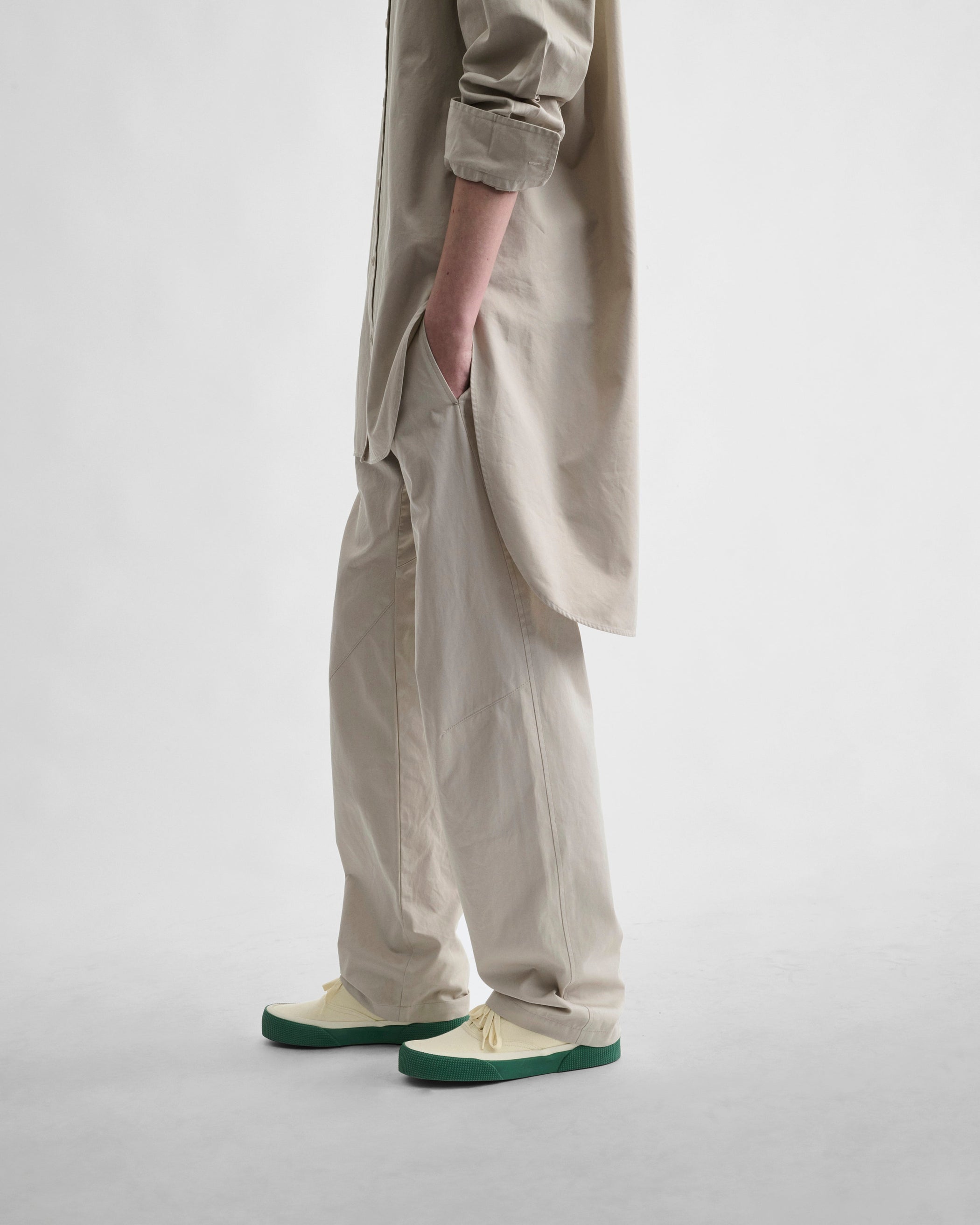 Side view model wearing ARCH TROUSERS in gum cotton
