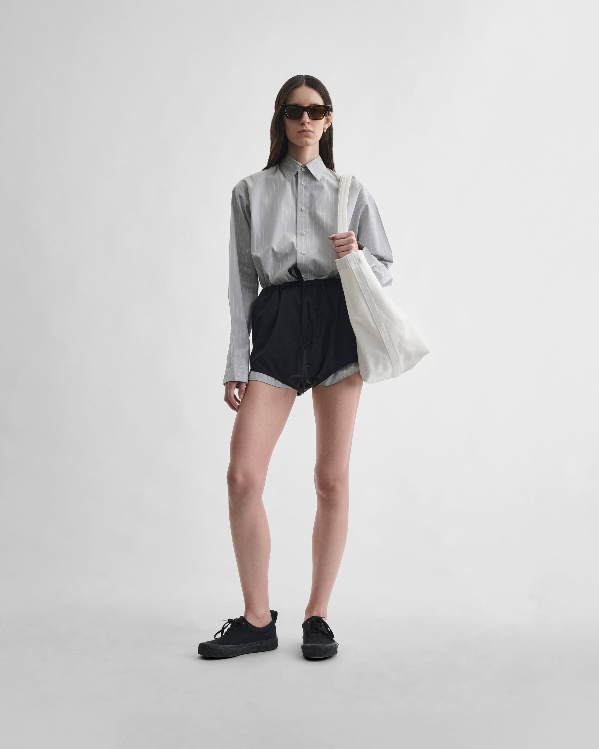 Front view of model wearing HIGH SHORTS in black cotton