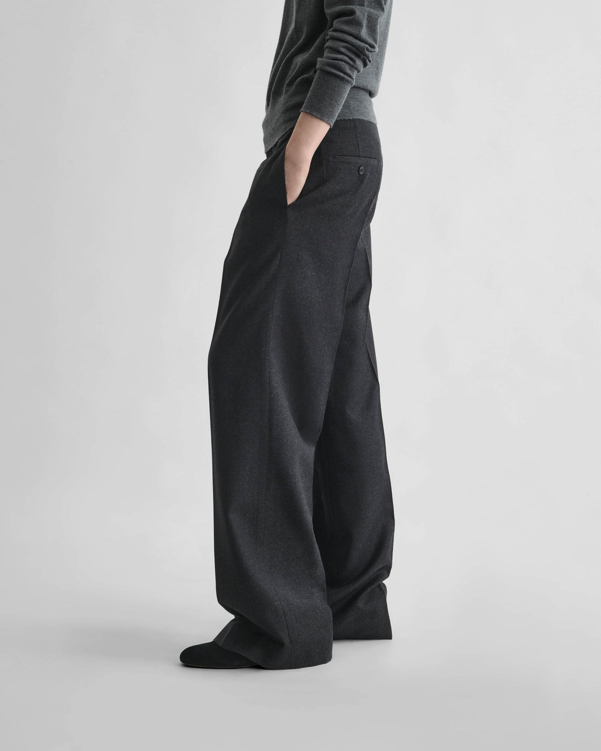 Side view of model wearing BOYISH TROUSERS in charcoal wool