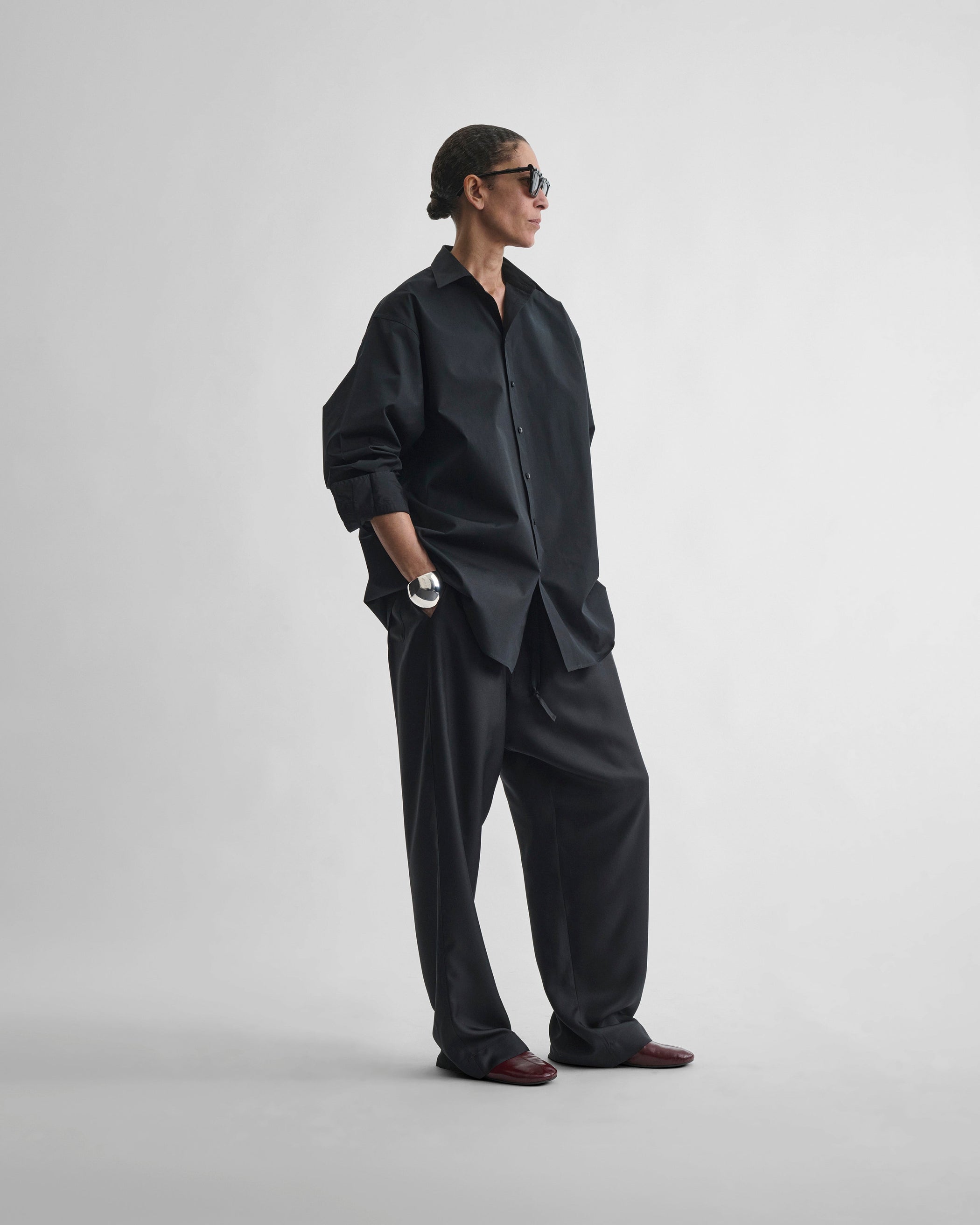 Side view of model wearing PYJAMA TROUSERS in black silk
