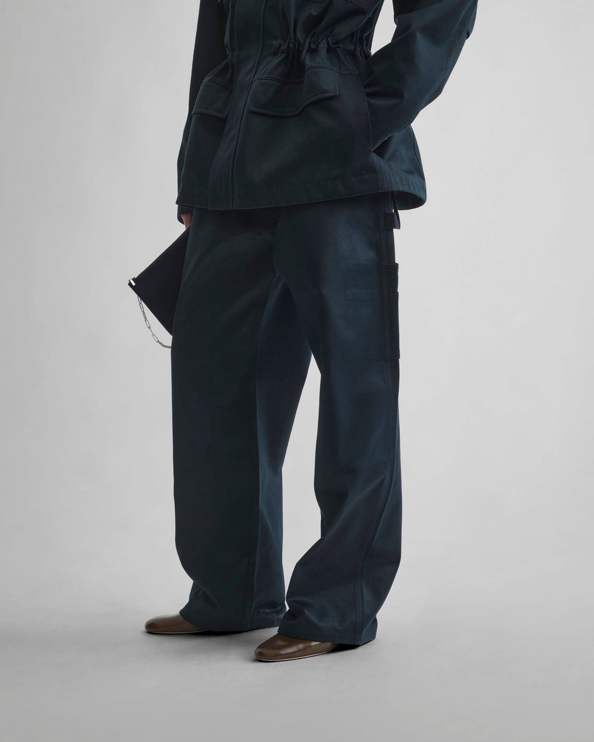 Angled front view of model wearing CARPENTER JEANS in black ink cotton
