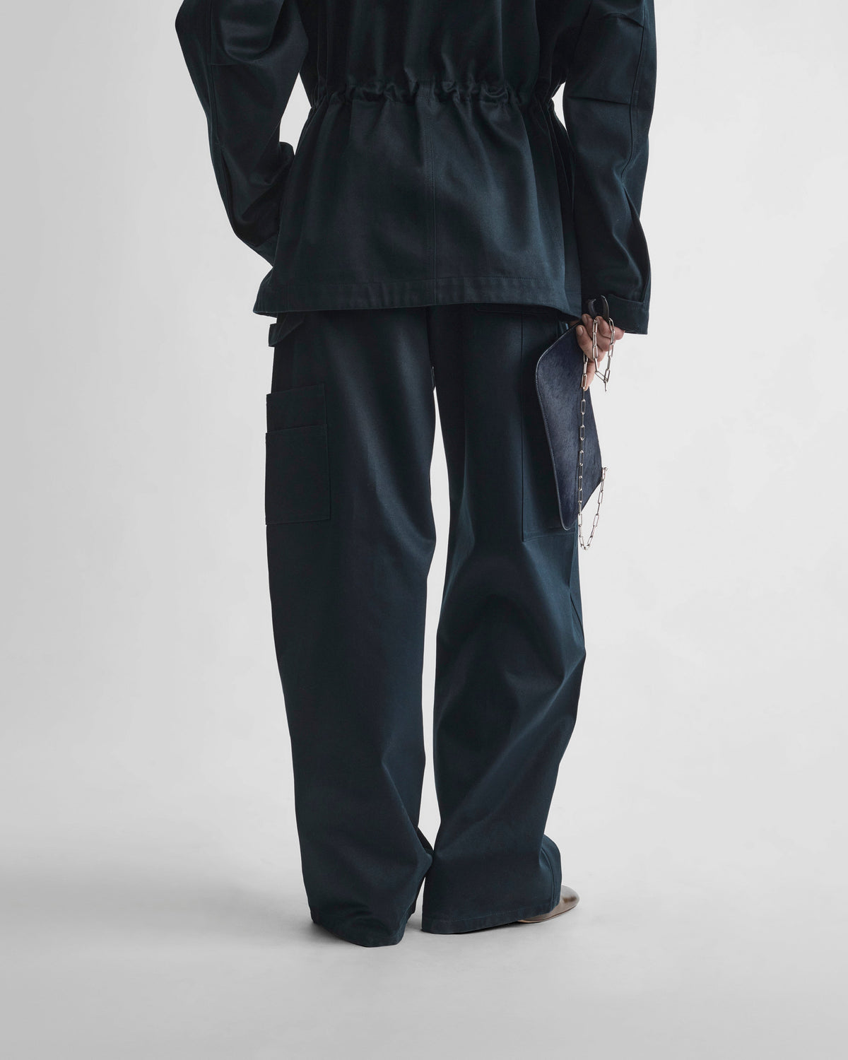 Back view of model wearing CARPENTER JEANS in black ink cotton
