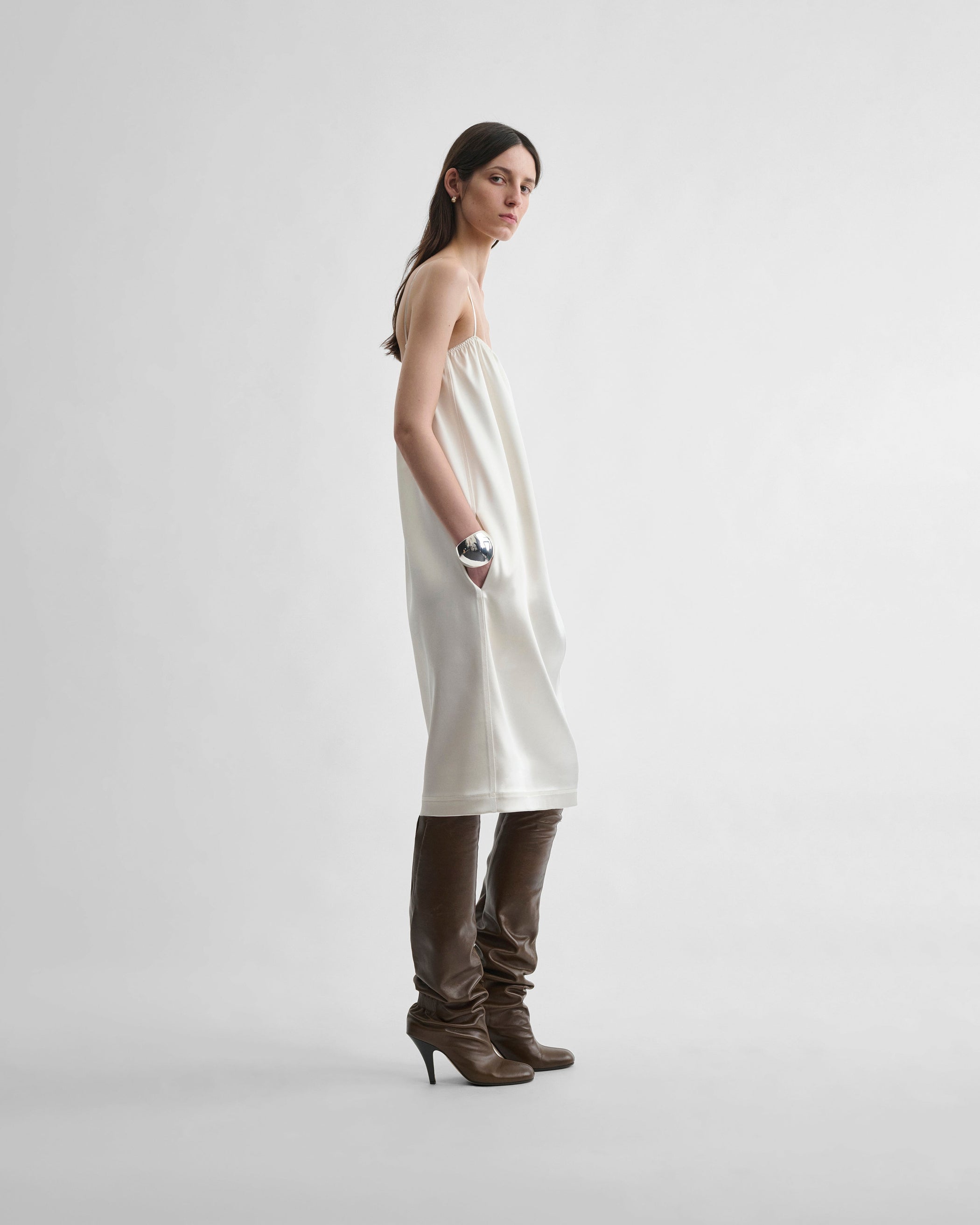 Side view of model wearing LIQUID SLIP DRESS in acid ivory silk