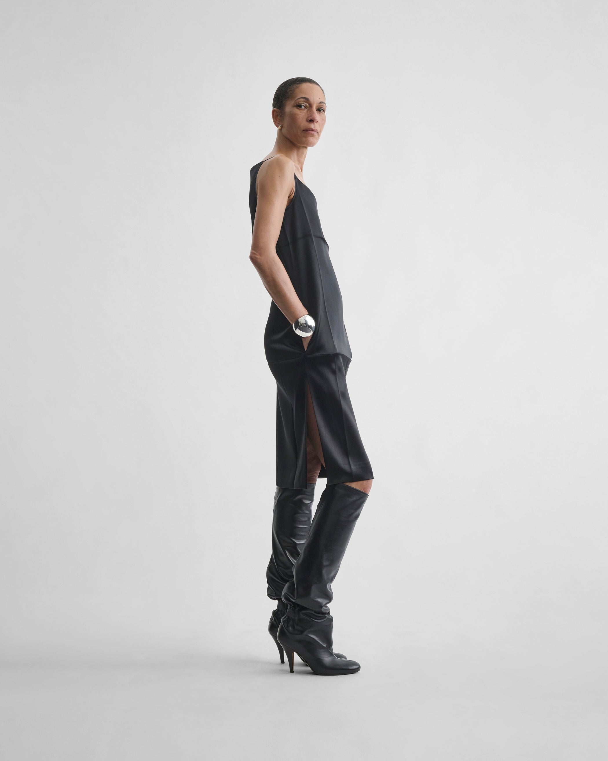 Side view of model wearing TANK DRESS in black silk