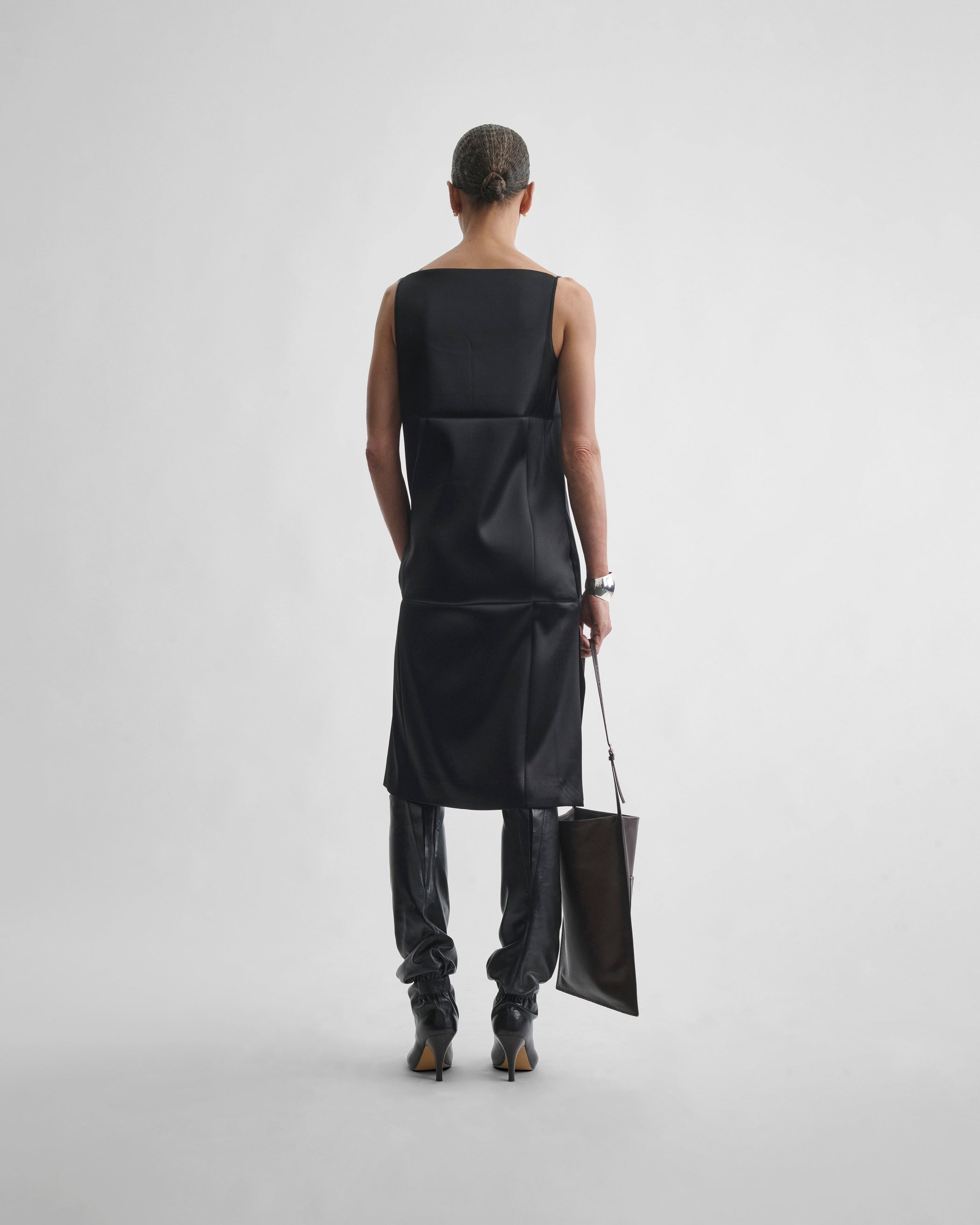 Back view of model wearing TANK DRESS in black silk