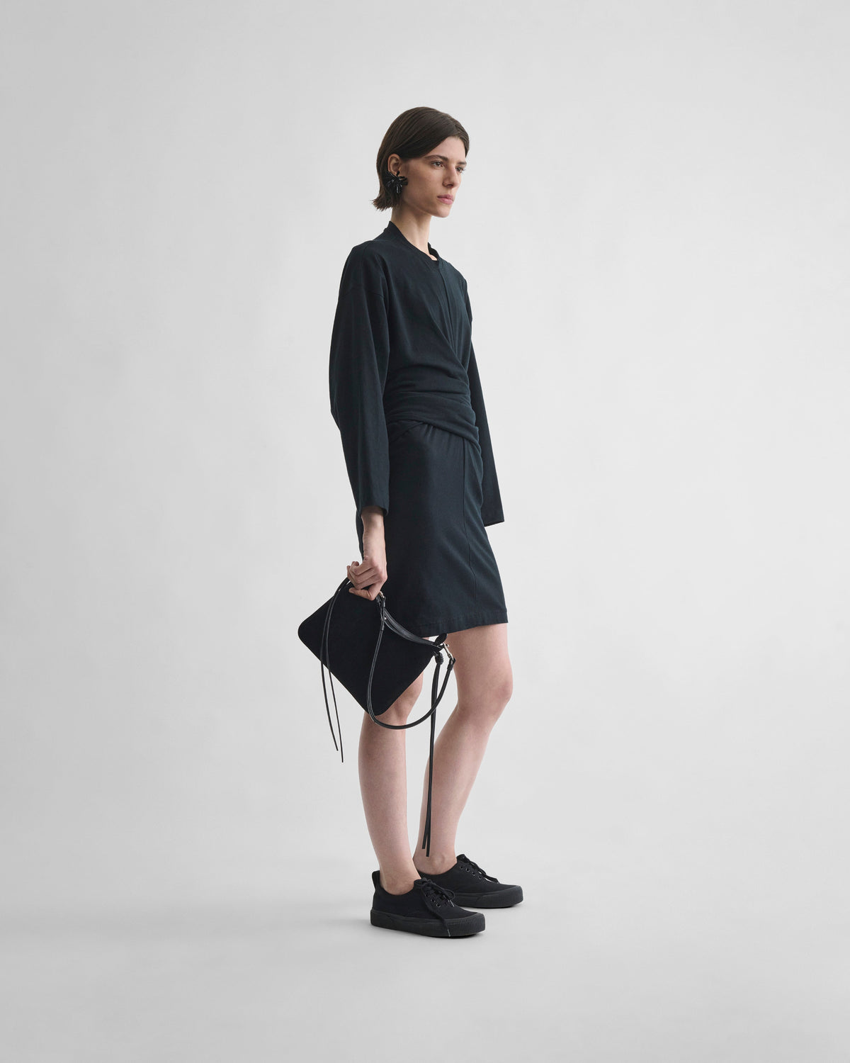 Side view of model wearing TIE T-SHIRT DRESS in black cotton