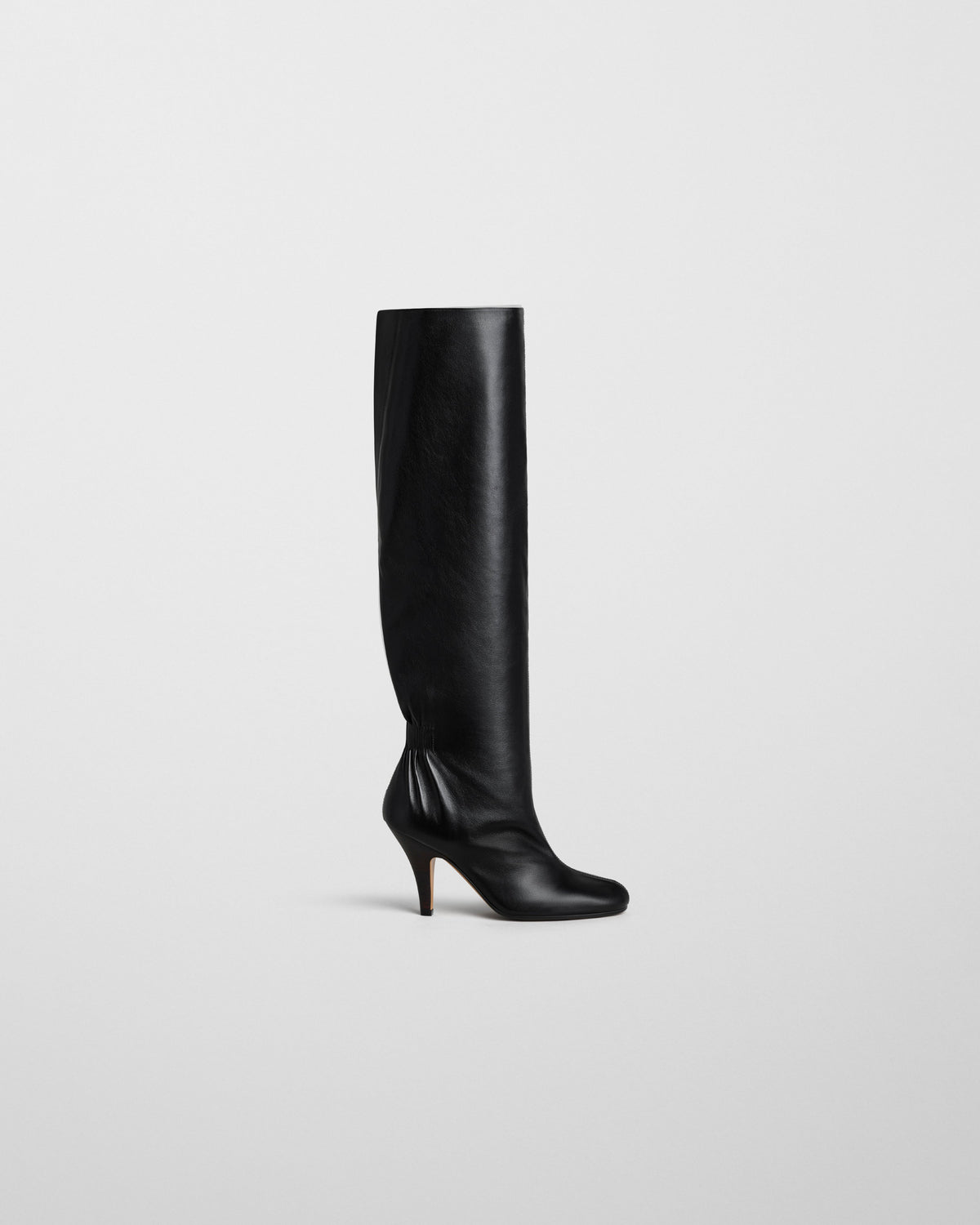Side view of SLOUCHY HIGH BOOT in black leather