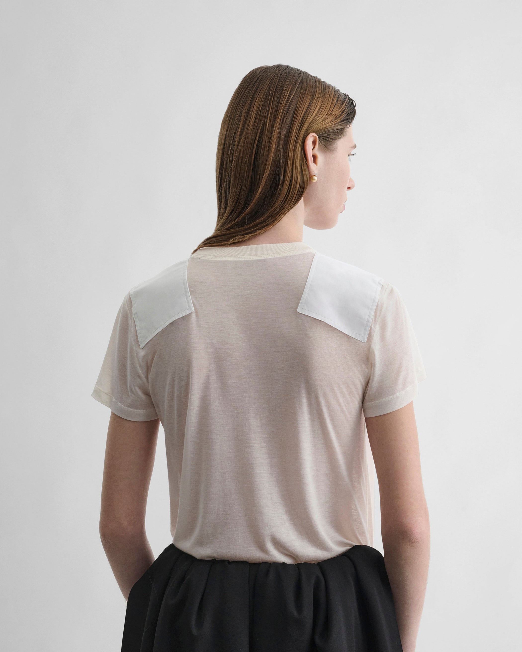 Back view of model wearing PATCH T-SHIRT in acid ivory cotton