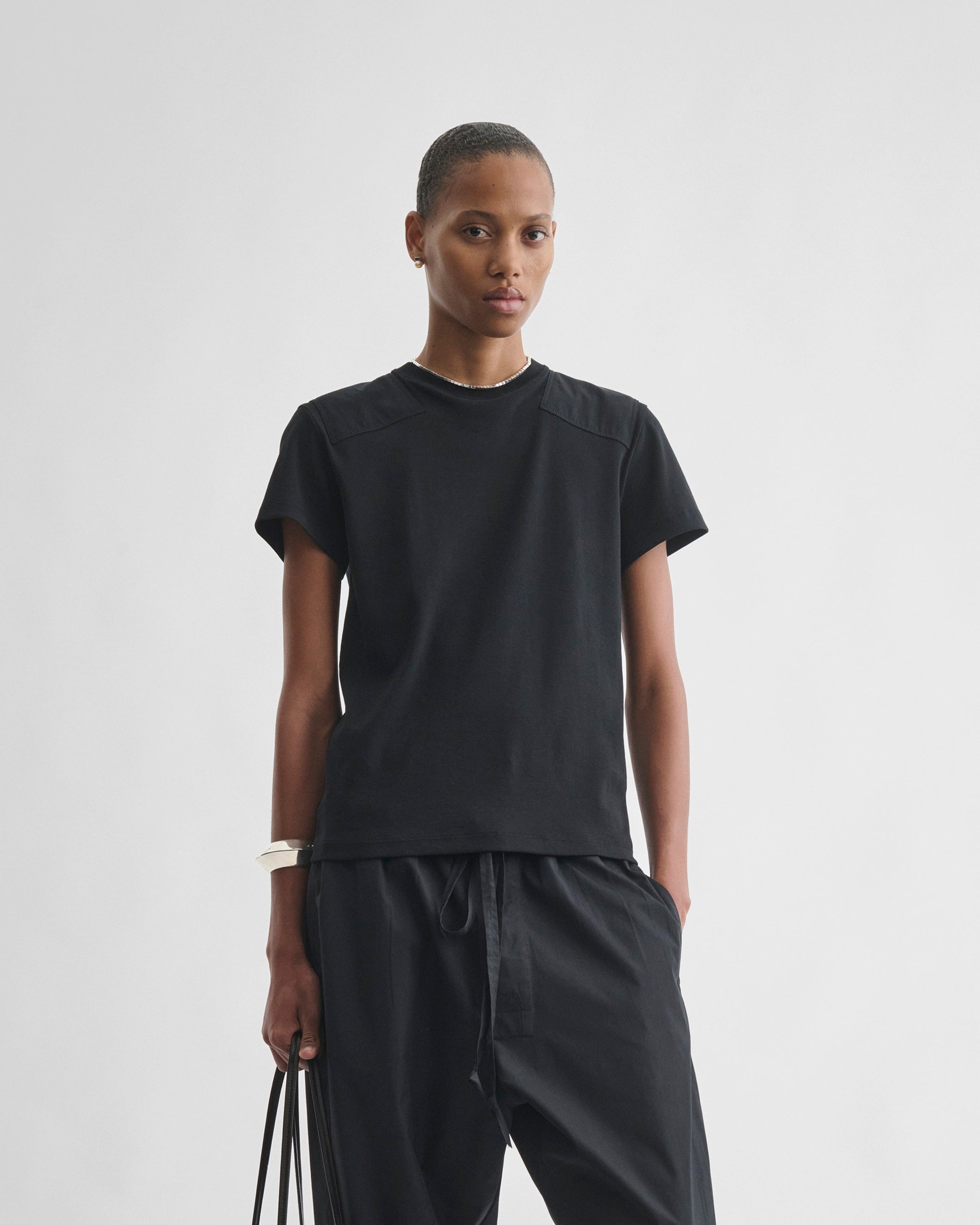 Front view of model wearing PATCH T-SHIRT in black cotton