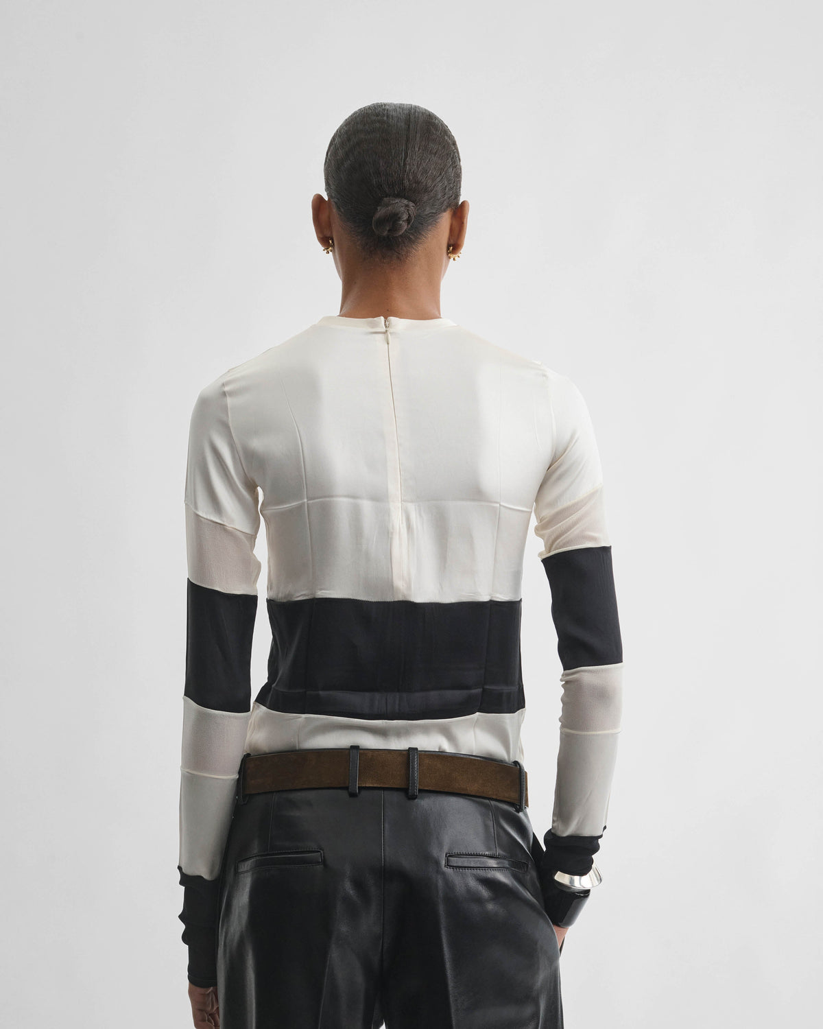 Back view of model wearing PANEL TOP in black white silk