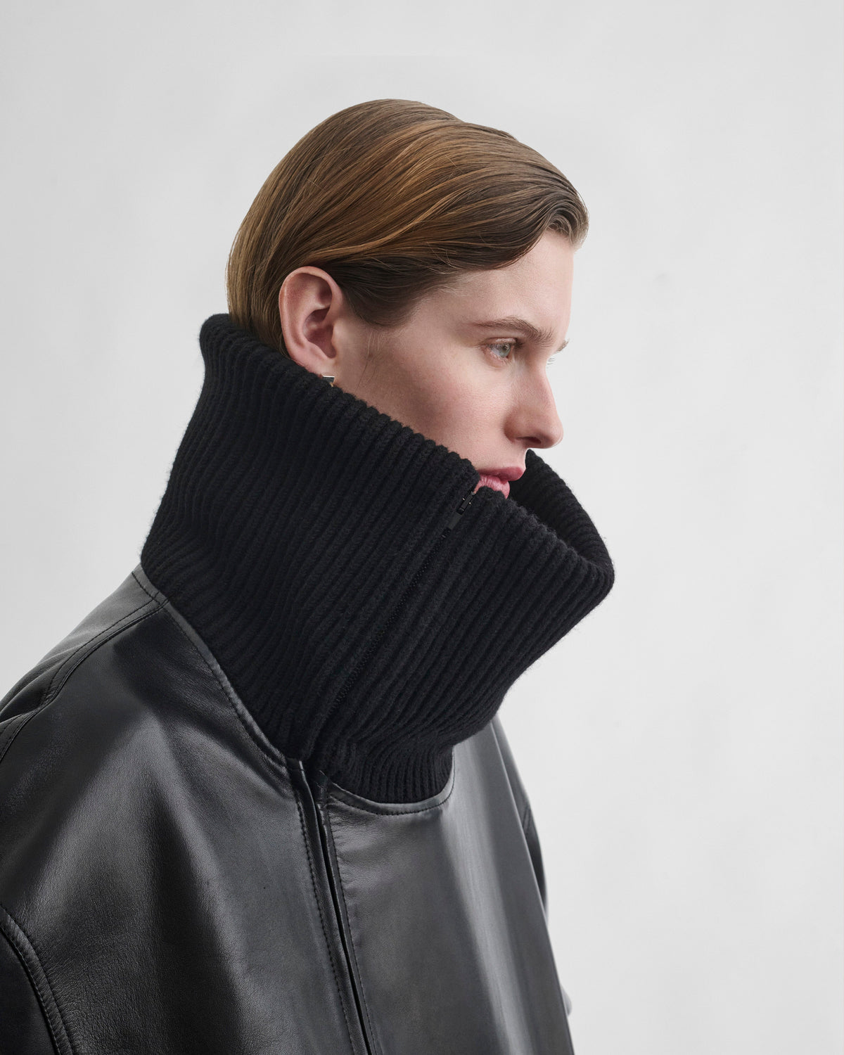 Detail view of model wearing RIB NECK JACKET in black leather