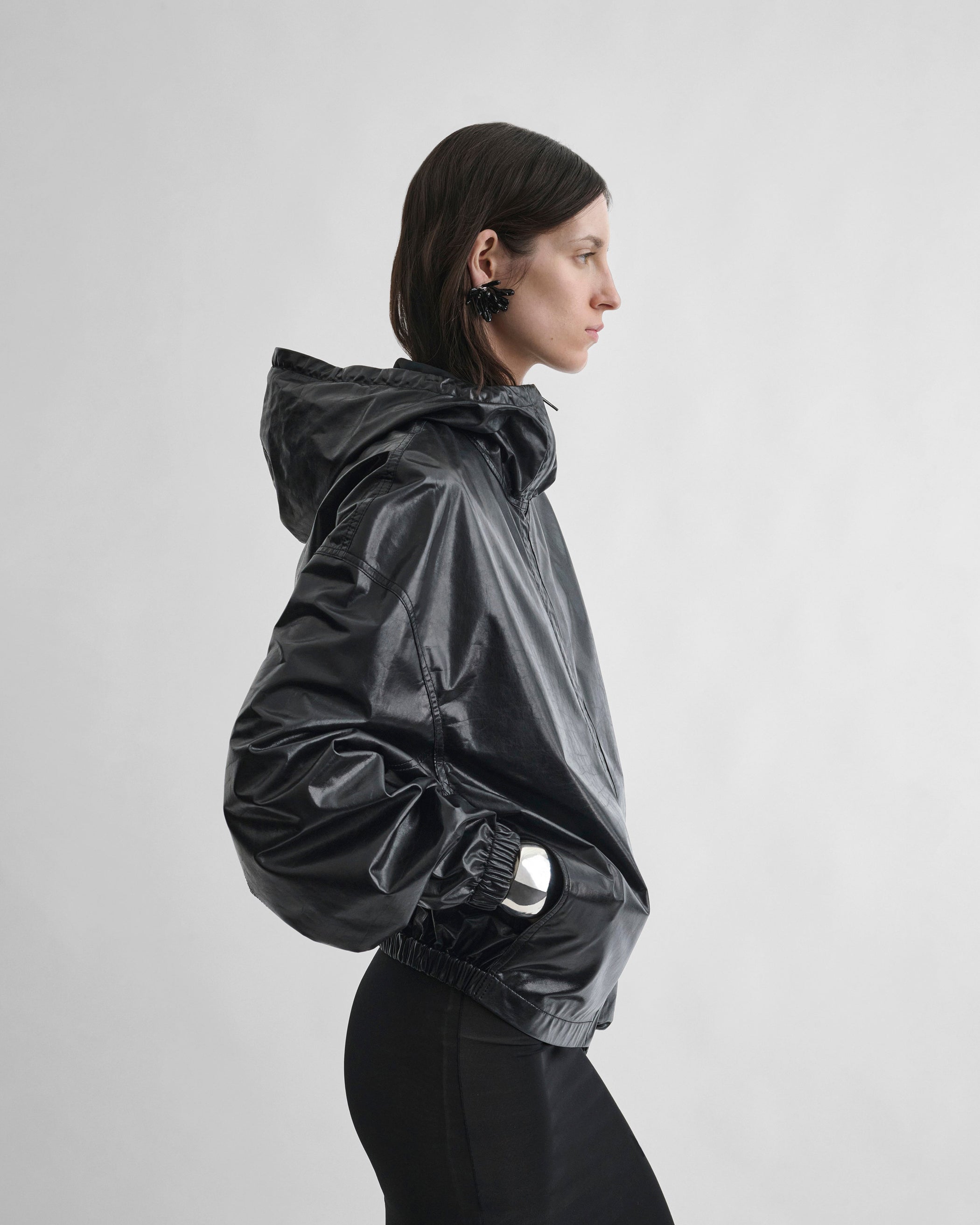 Side view of model wearing ANORAK in black leather