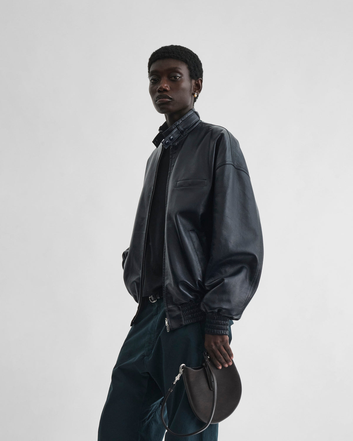 Front view of model wearing CLASSIC BOMBER in black ink leather