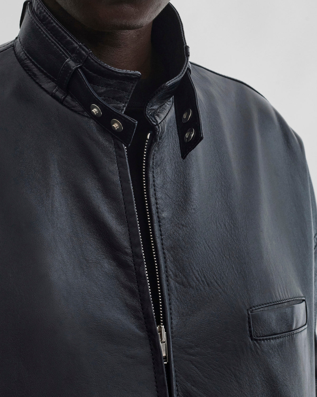 Front detail view of model wearing CLASSIC BOMBER in black ink leather