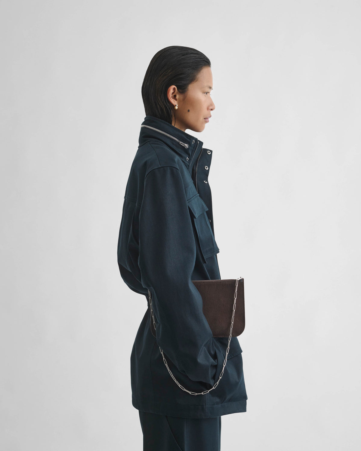 Side view of model wearing UTILITY JACKET in black ink cotton
