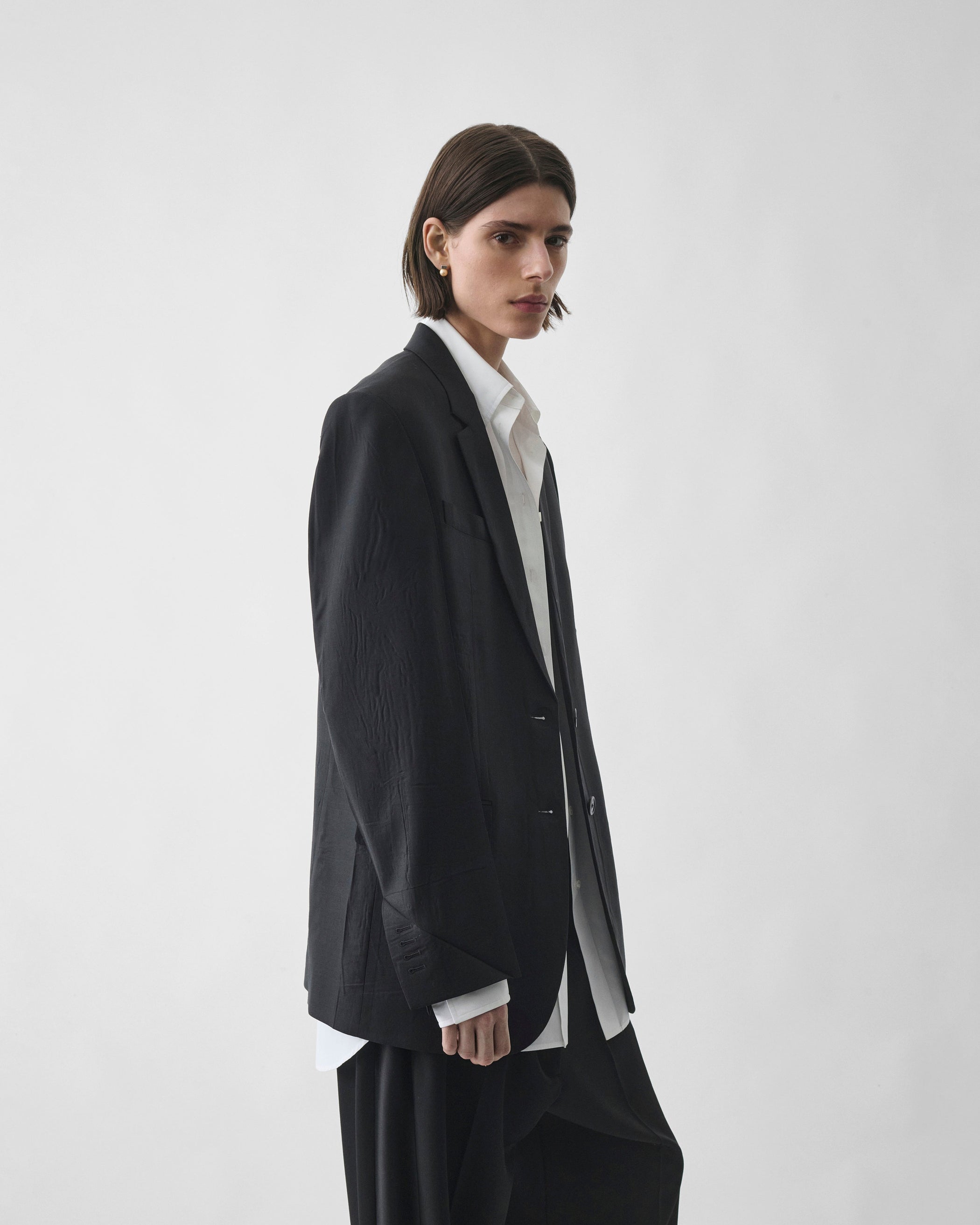 Front view of model wearing NEAPOLITAN JACKET in black wool