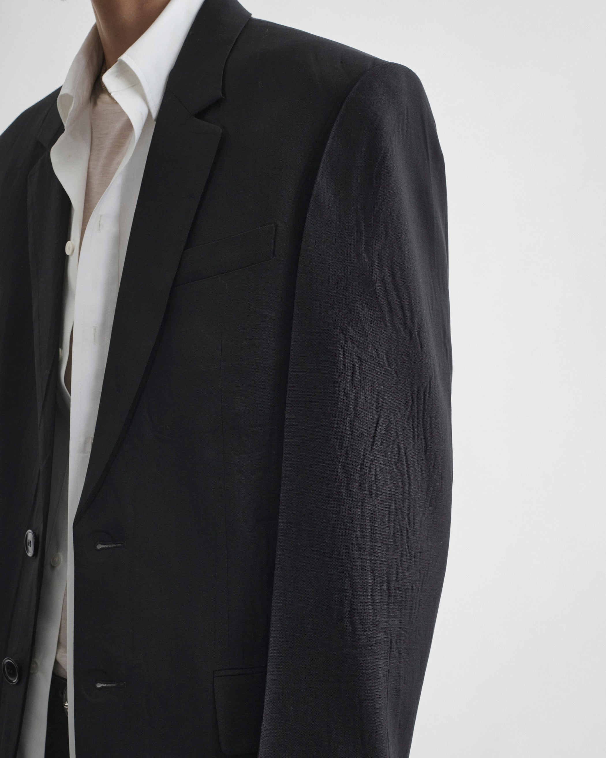Detail view of model wearing NEAPOLITAN JACKET in black wool