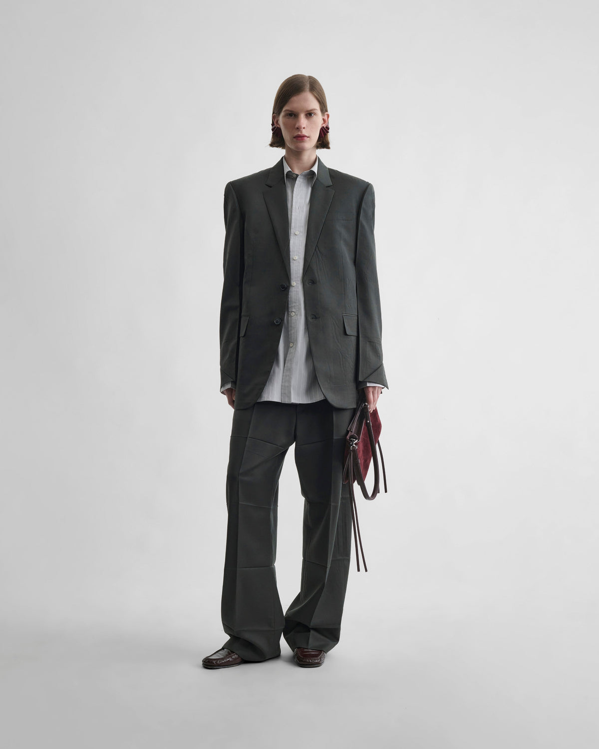 Front view of model wearing NEAPOLITAN JACKET in green bronze wool