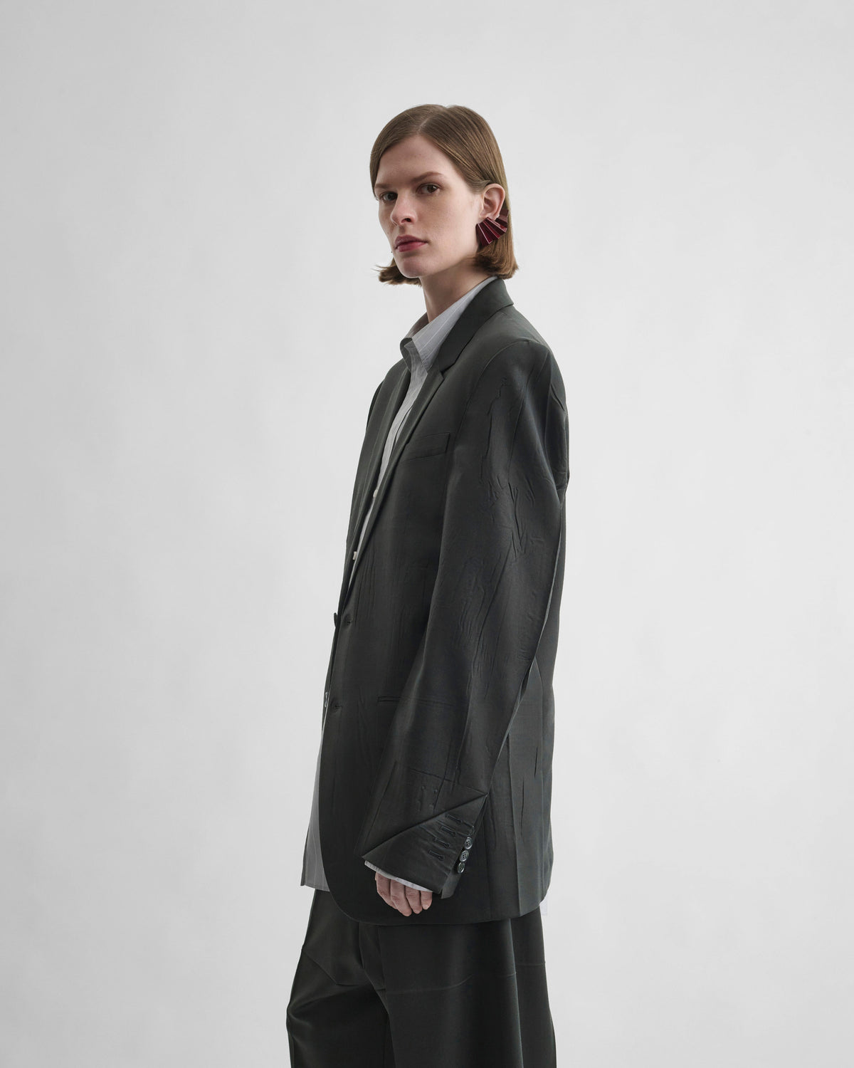 Side view of model wearing NEAPOLITAN JACKET in green bronze wool
