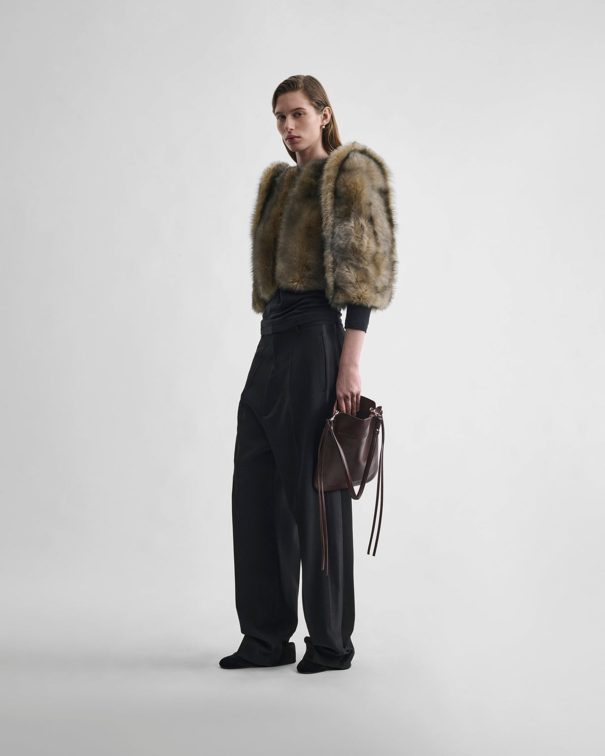 Angled front view of model wearing DANCER JACKET in blue apricot shearling