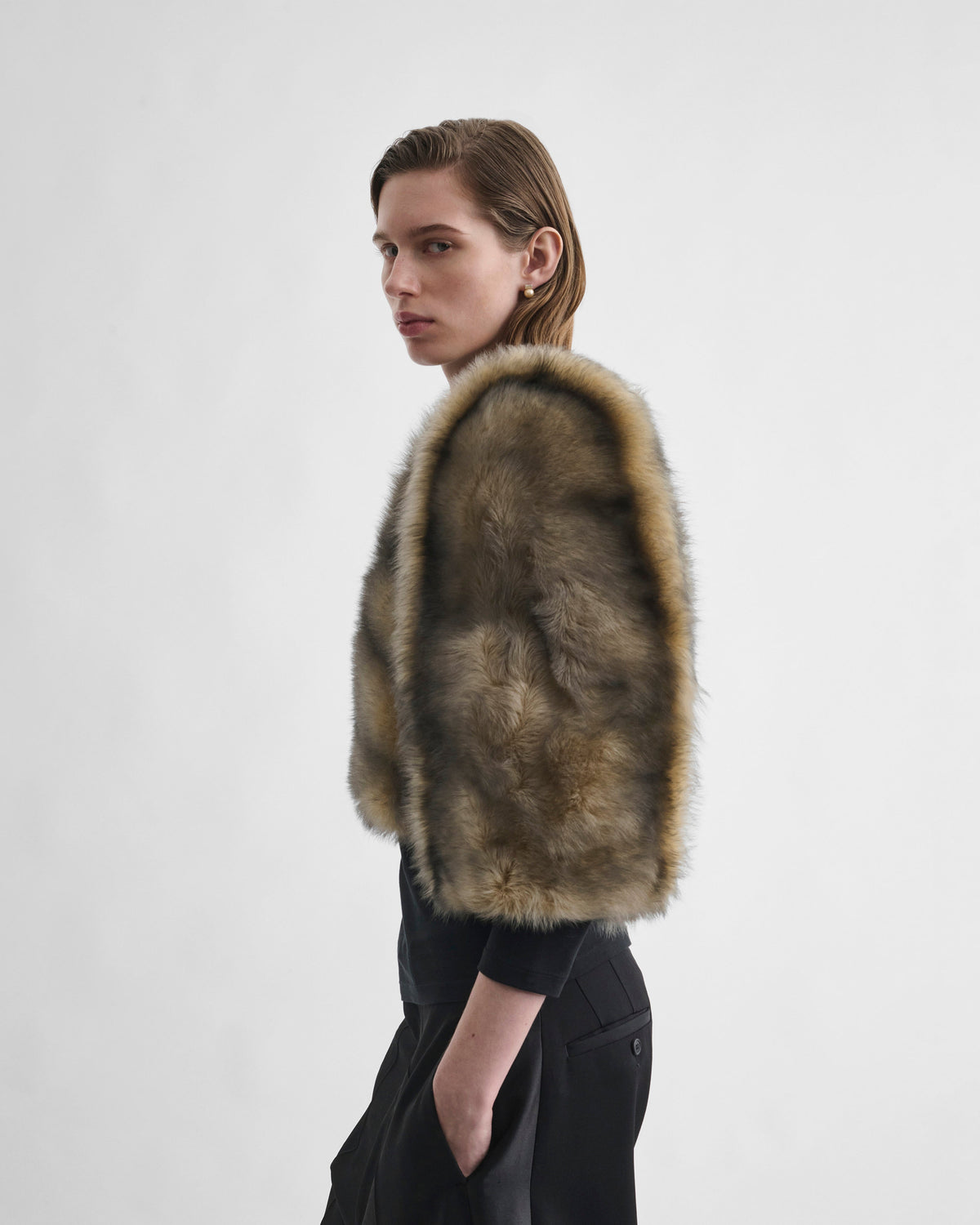 Side view of model wearing DANCER JACKET in blue apricot shearling