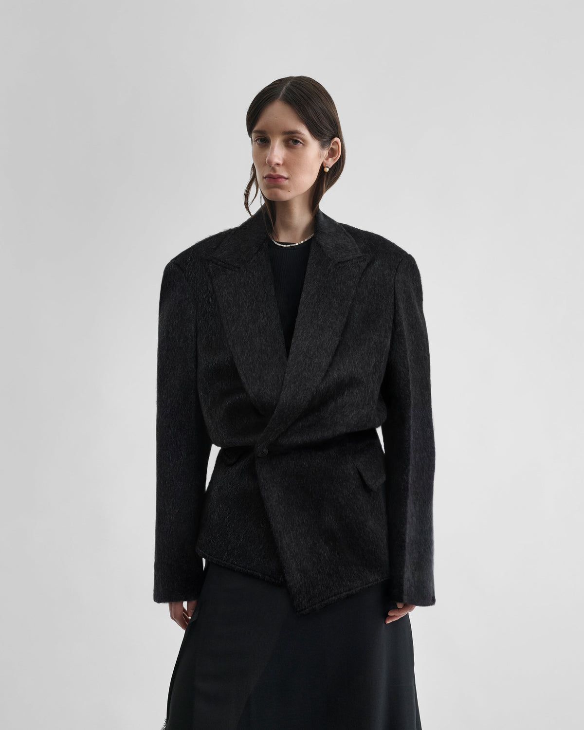 Close front view of model wearing Front view of KINKED JACKET in anthracite wool