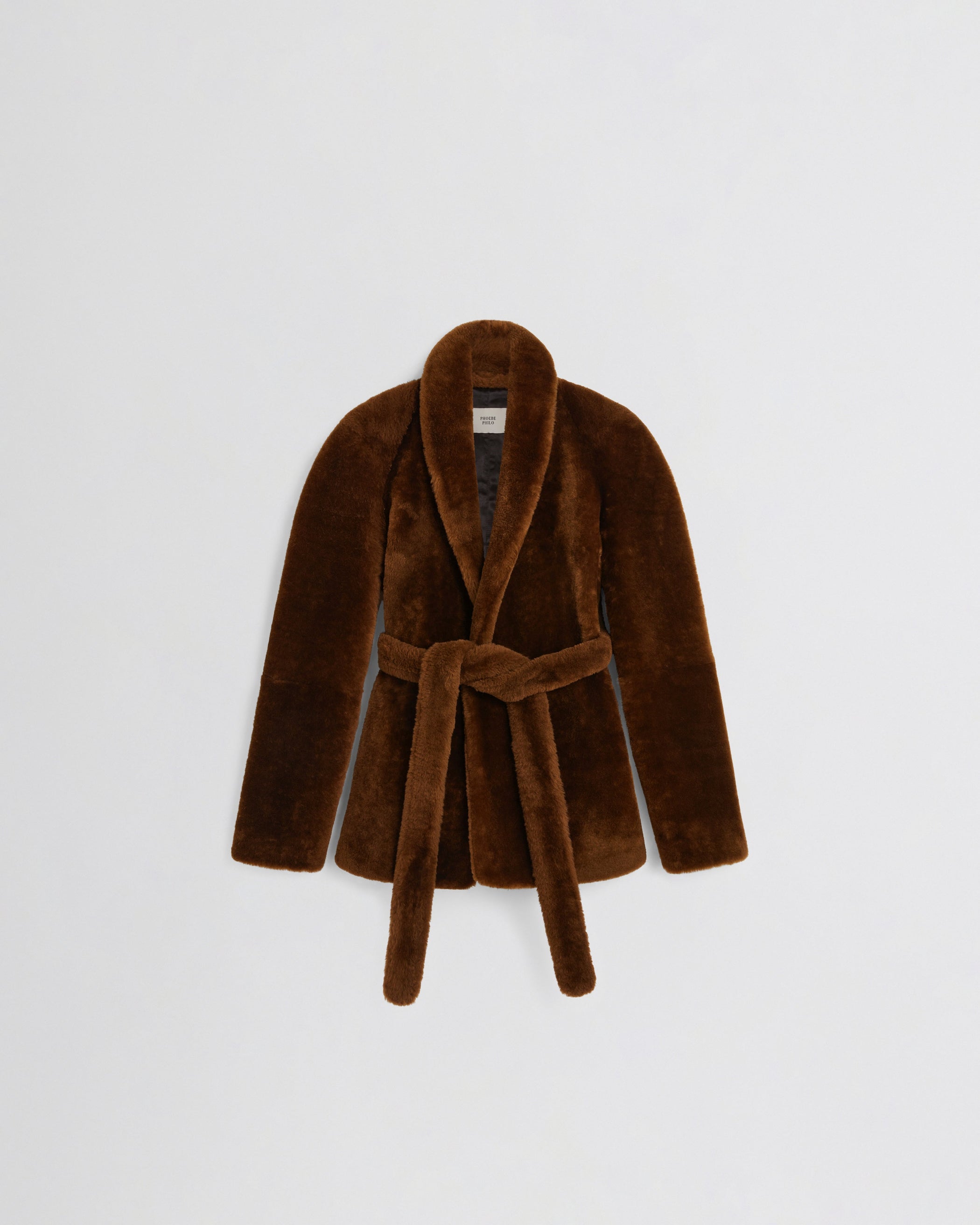 Flat front view of BELTED ROBE JACKET in burnt orange shearling