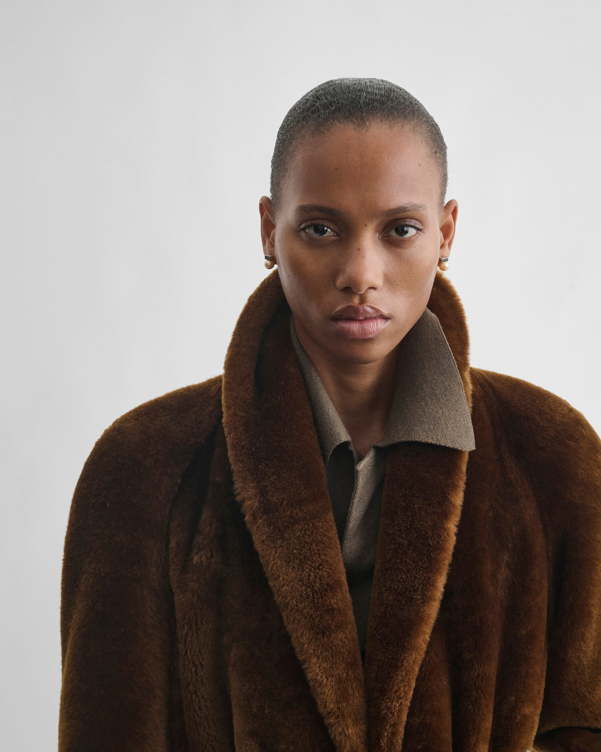 Front detail view of model wearing BELTED ROBE JACKET in burnt orange shearling
